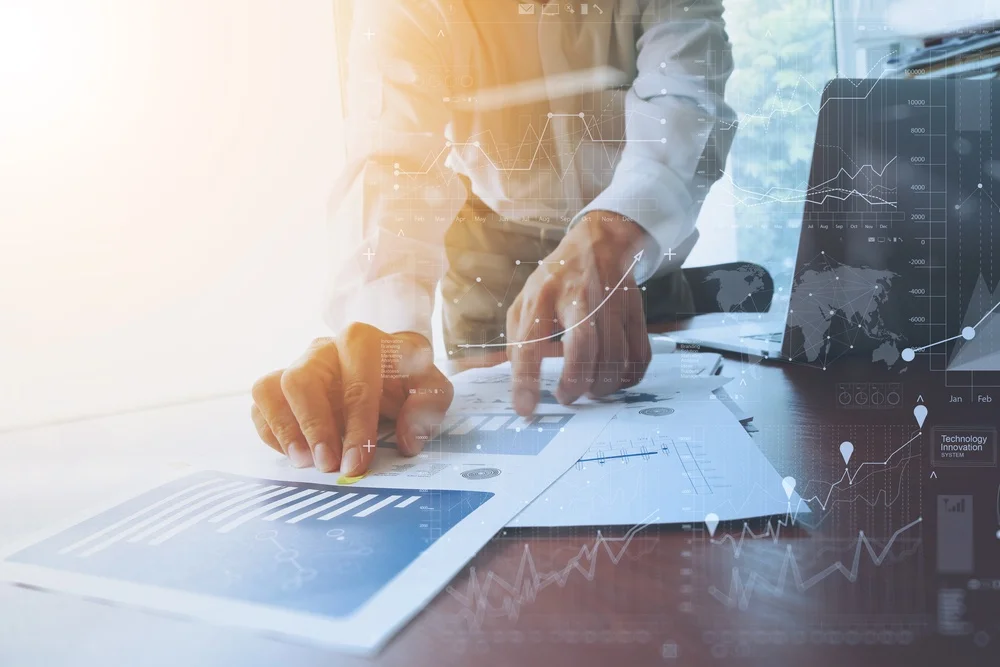 business documents on office table with smart phone and digital tablet and graph financial with social network diagram and man working in the background.jpg
