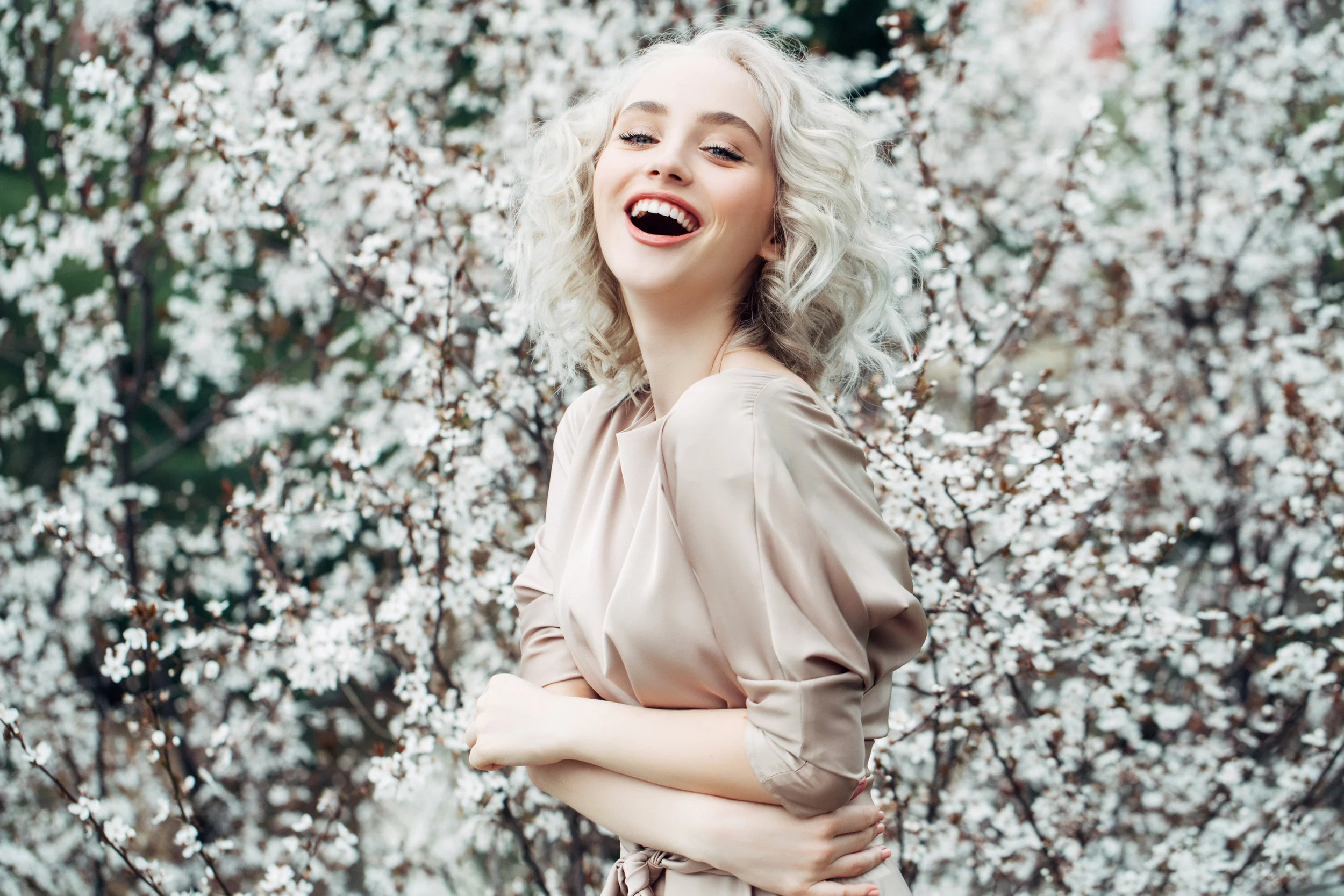 Beautiful-girl-on-the-background-of-spring-bush-914169286_3869x2579.jpeg