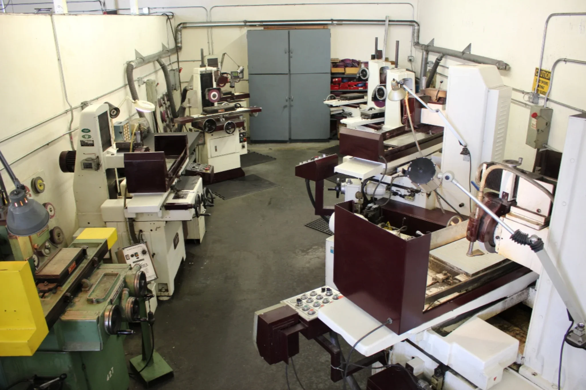 Grinding department with multiple precision machines used for tool and die finishing operations