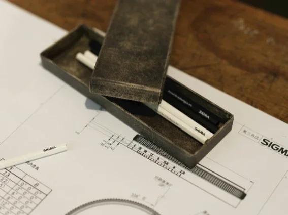 Measurement tools and technical drawings used during the planning and layout stage of precision manufacturing