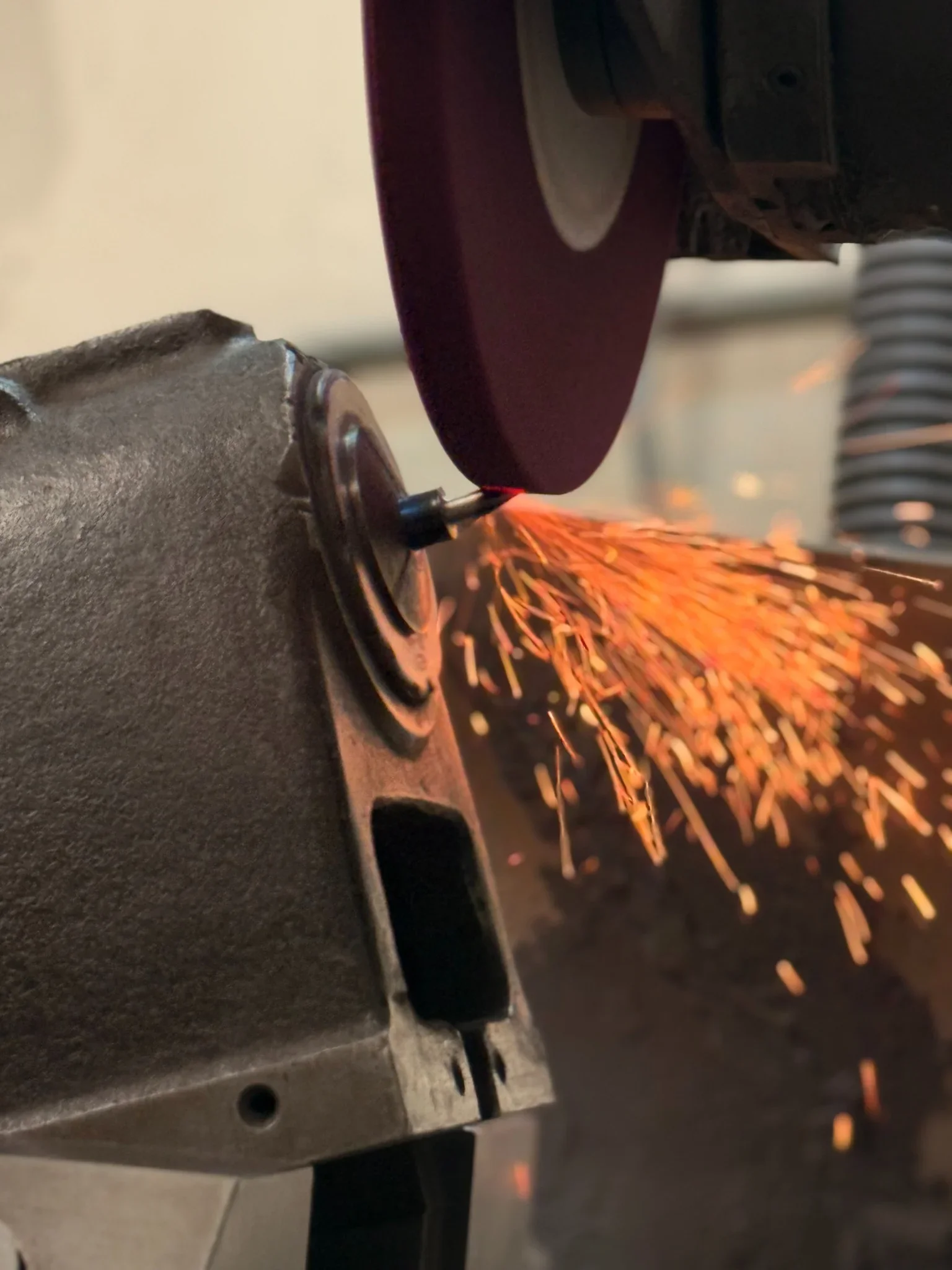 Precision surface grinding operation producing sparks during metal finishing in a tool and die shop