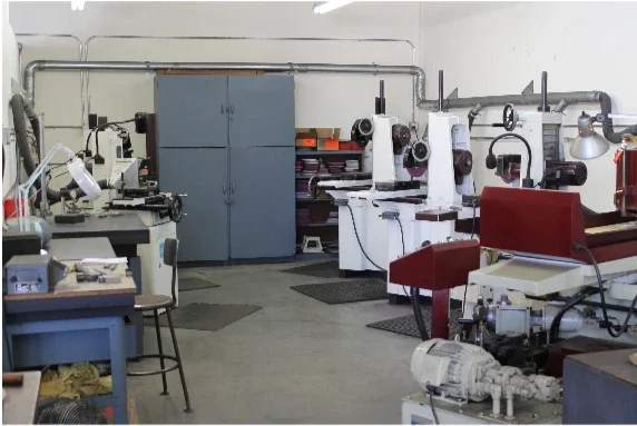 Wide view of the machining area inside T&D Resources, showing multiple grinding machines used for custom die work