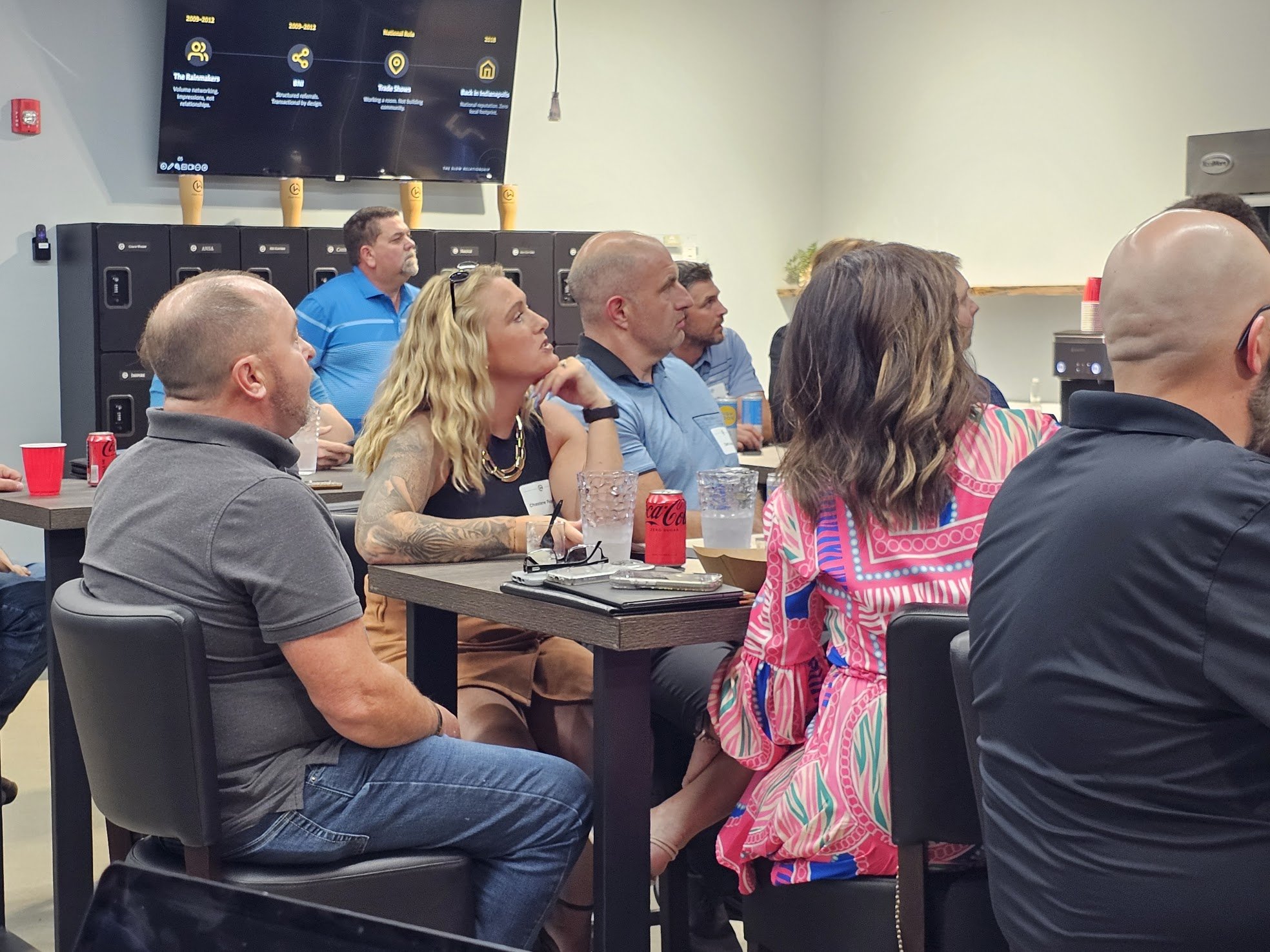A group of business professionals engaging at a corporate networking event.