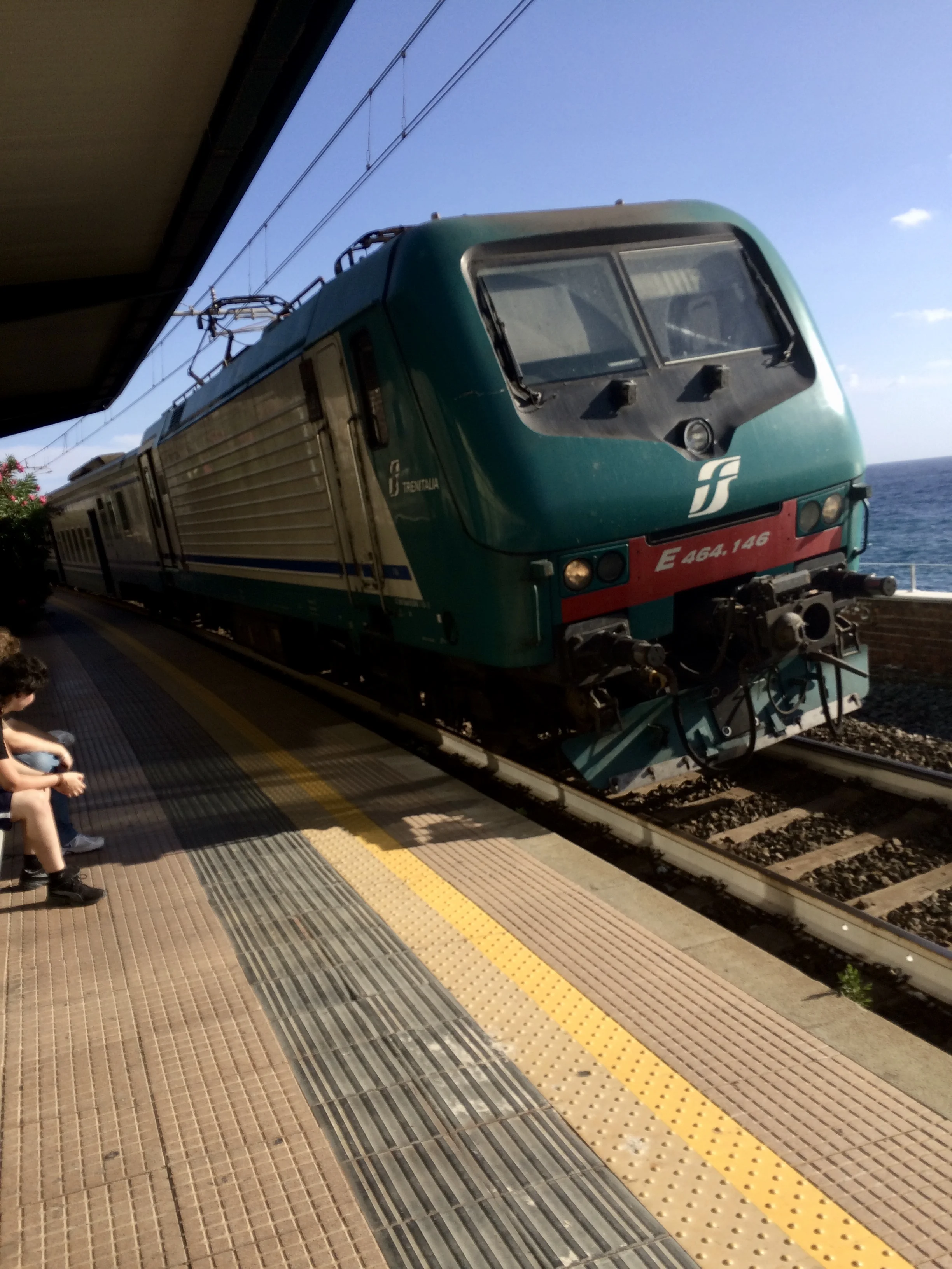 Waiting for the train with friends, in Italy, 2015.