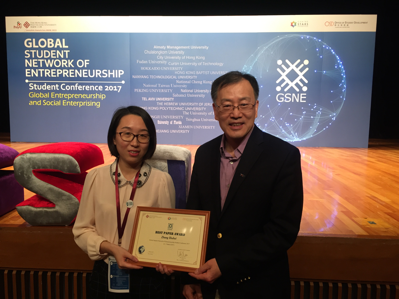 Presenting an award to a Peking University student attending the Global Student Network for Entrepreneurship competition