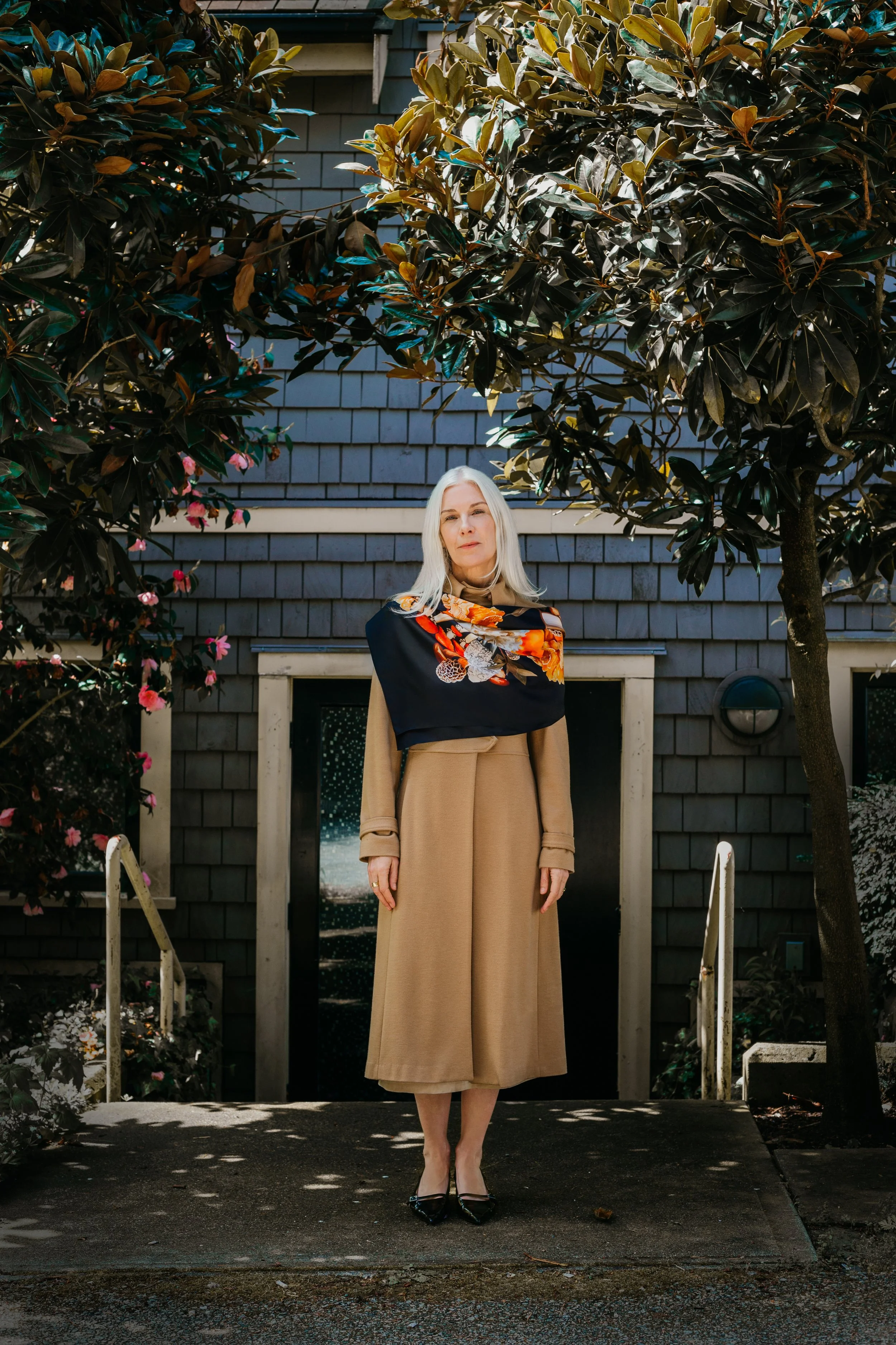 UNITY - in Black - designer silk scarf — styled with a beige coat outdoors