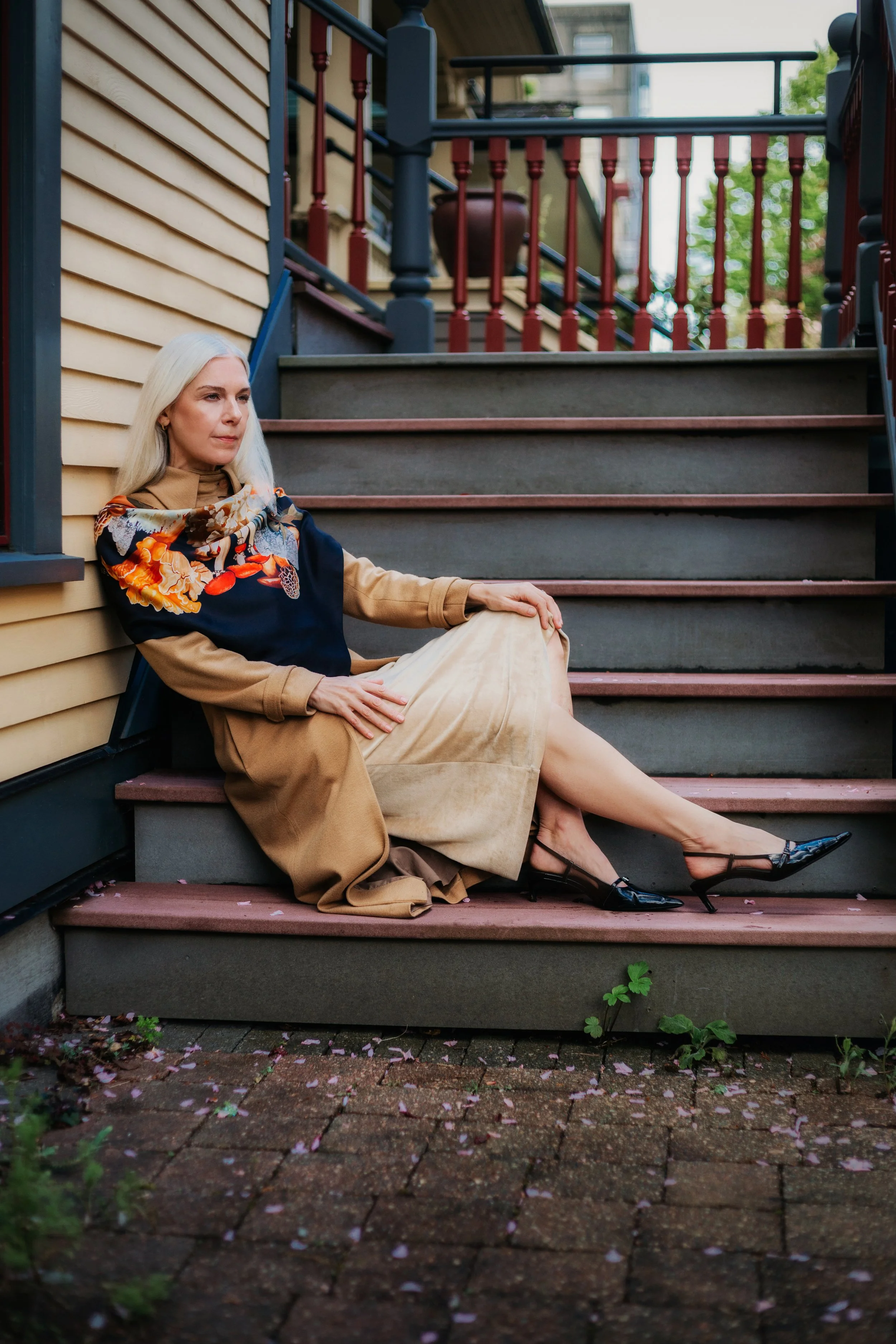 UNITY - in Black - designer silk scarf — worn seated on outdoor steps