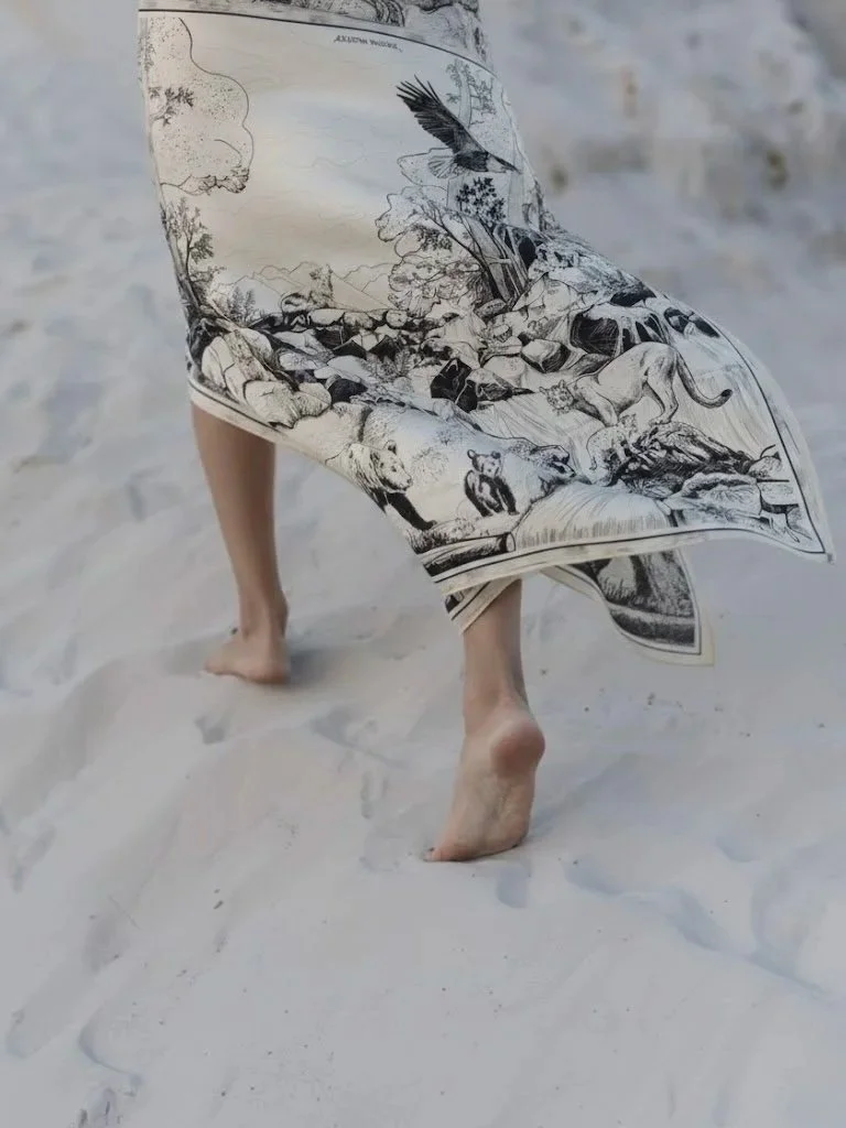 DEEP FOREST in black and white wool silk shawl — worn barefoot on the beach