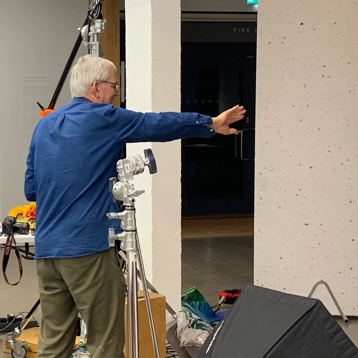 Martin Parr directs a portrait session Camera: iPhone XS Max Shutter speed: 1/50 sec Aperture: f/1.8 ISO: 64 Photo: Kirk McElhearn