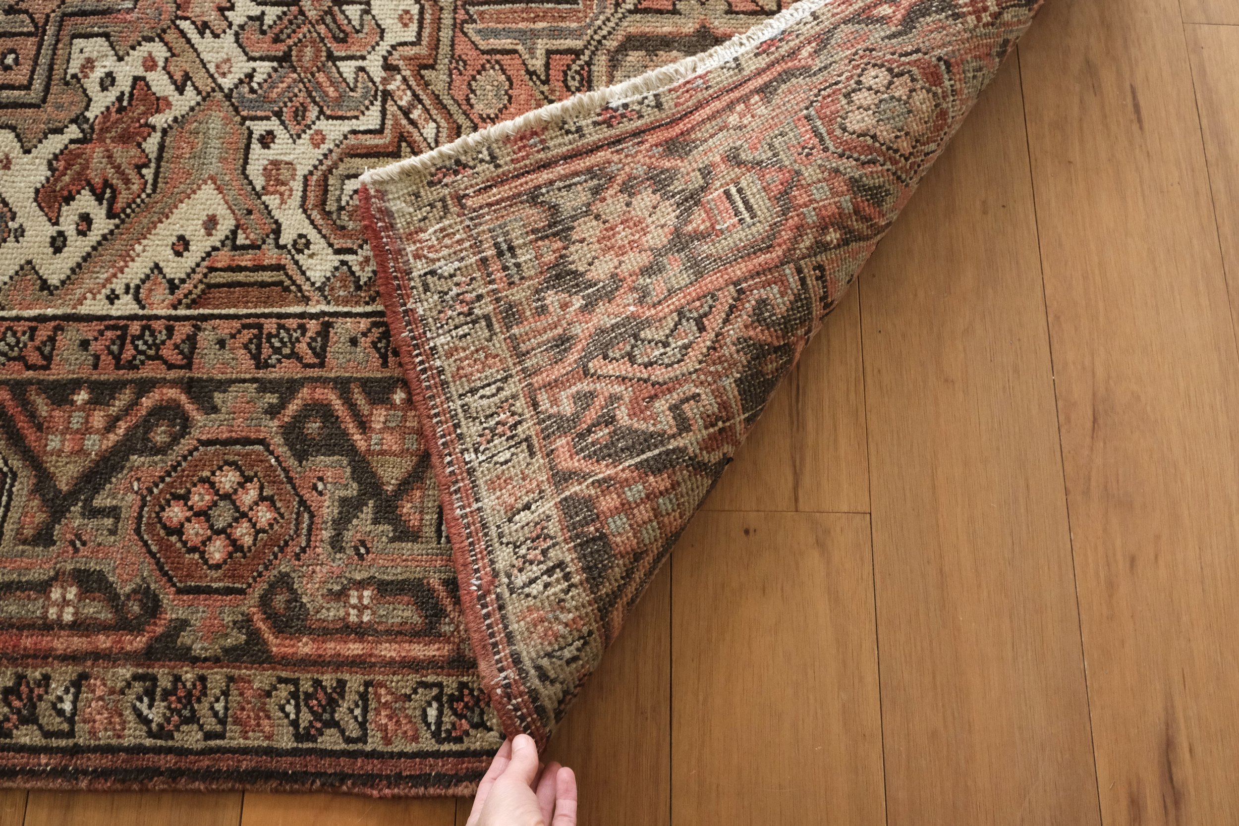 closeup photo of backside of rug showing big knot pattern