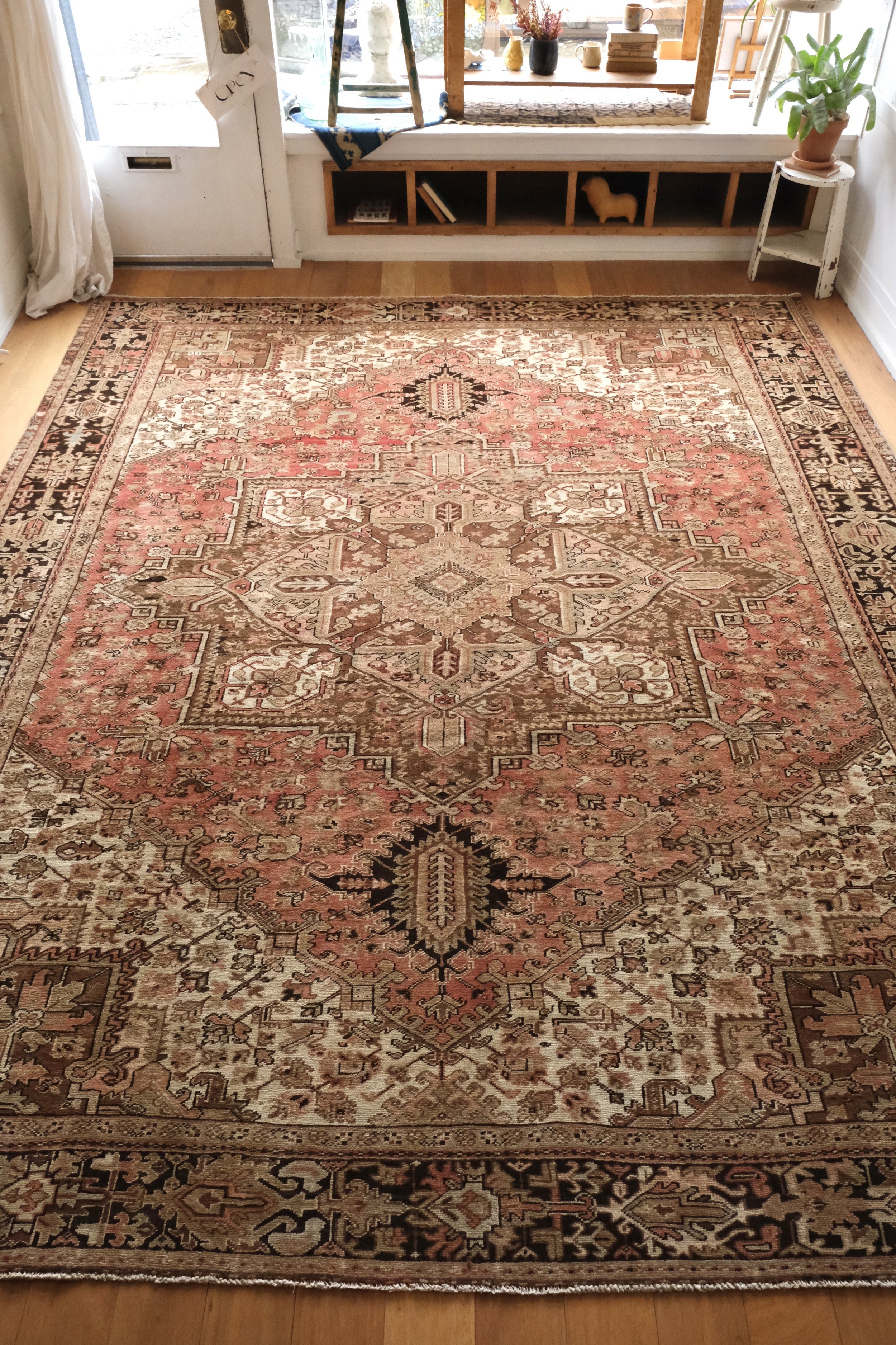 full view of vintage Persian Heriz rug displayed more overhead and lengthwise in the studio