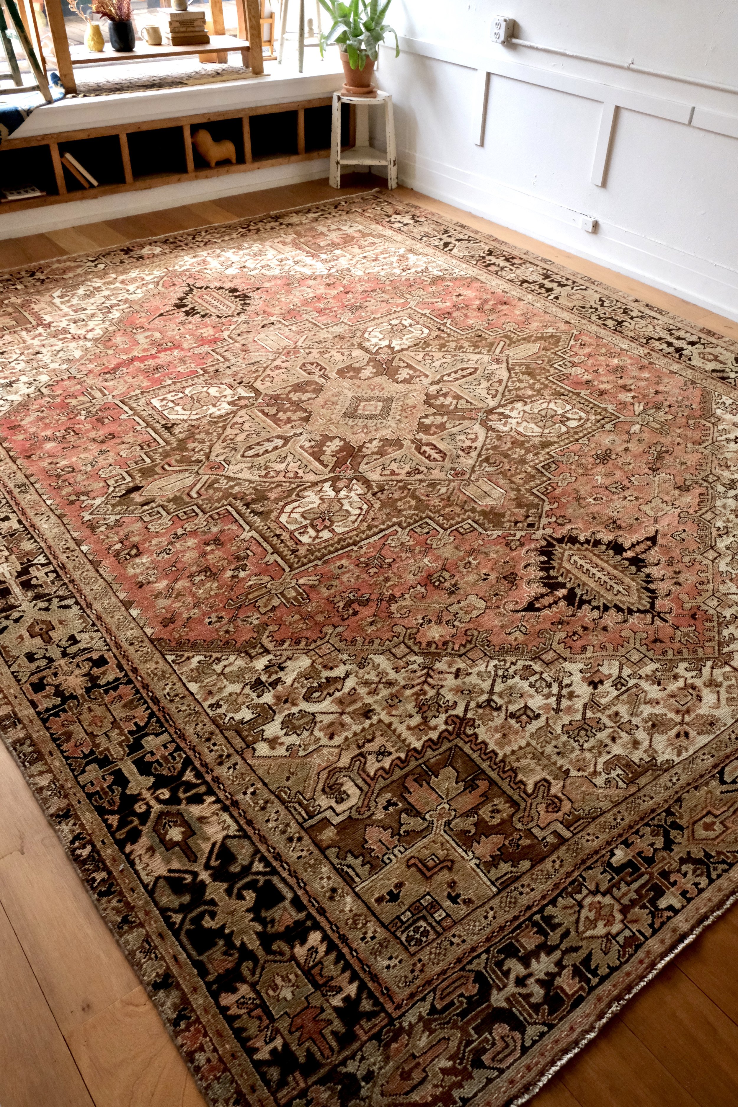 vintage Persian Heriz rug displayed at an angle in the studio