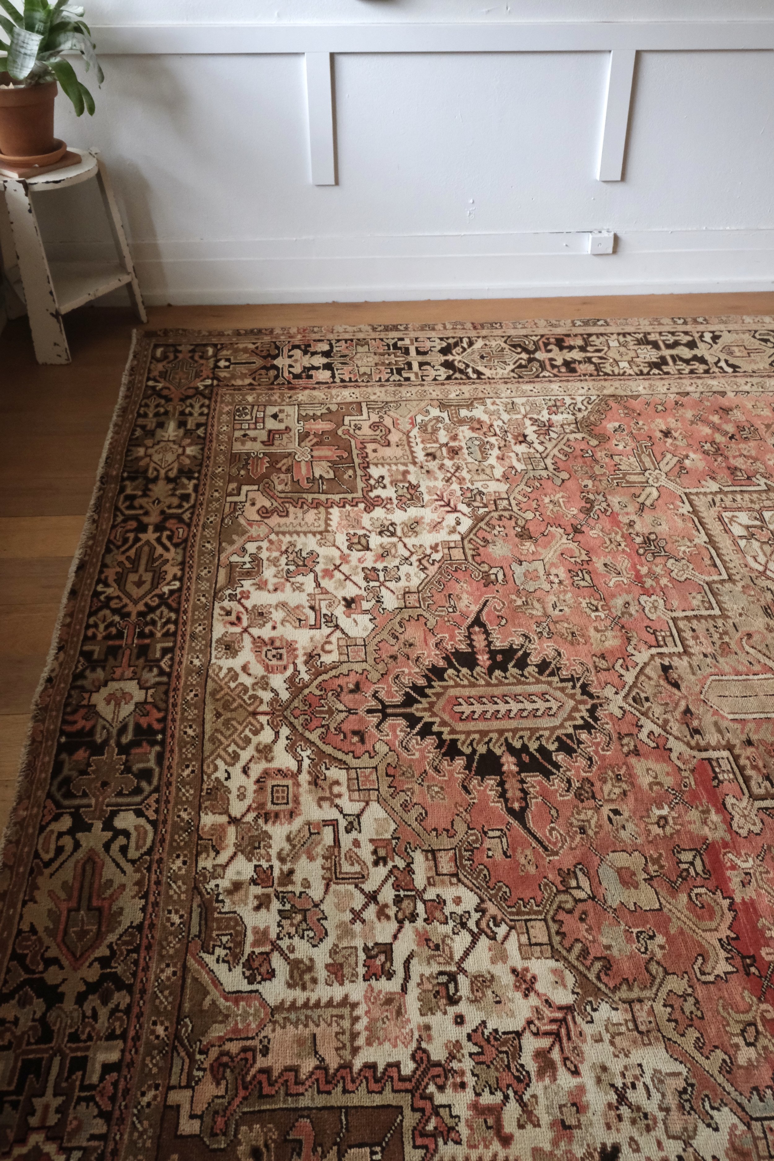 a close up vintage Persian Heriz rug displayed horizontally in the studio