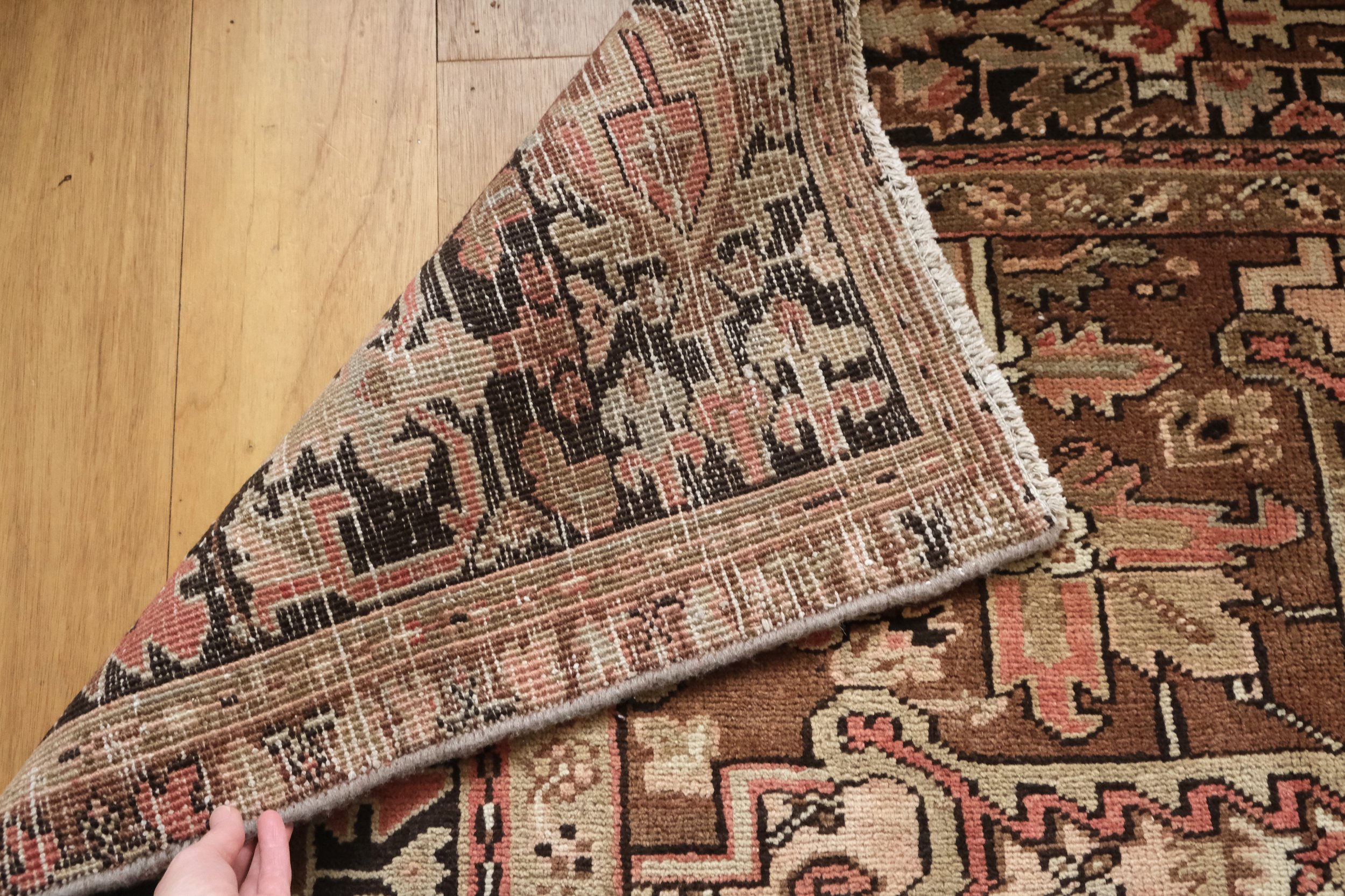 Close up of backside of vintage rug showing tightness of hand knotted pattern