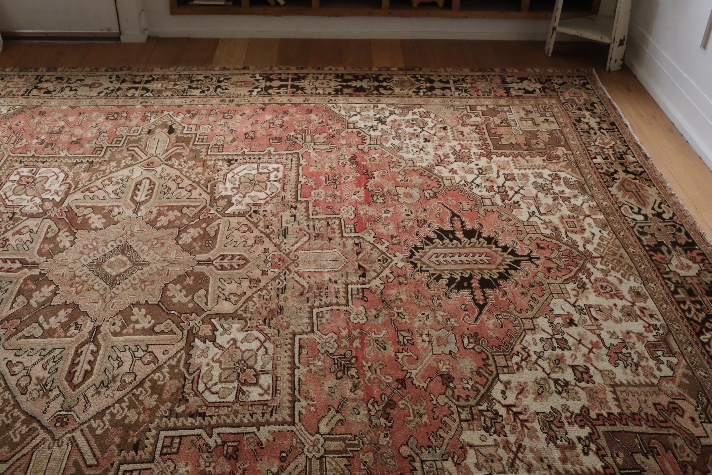 vintage Persian Heriz rug displayed horizontally in the studio