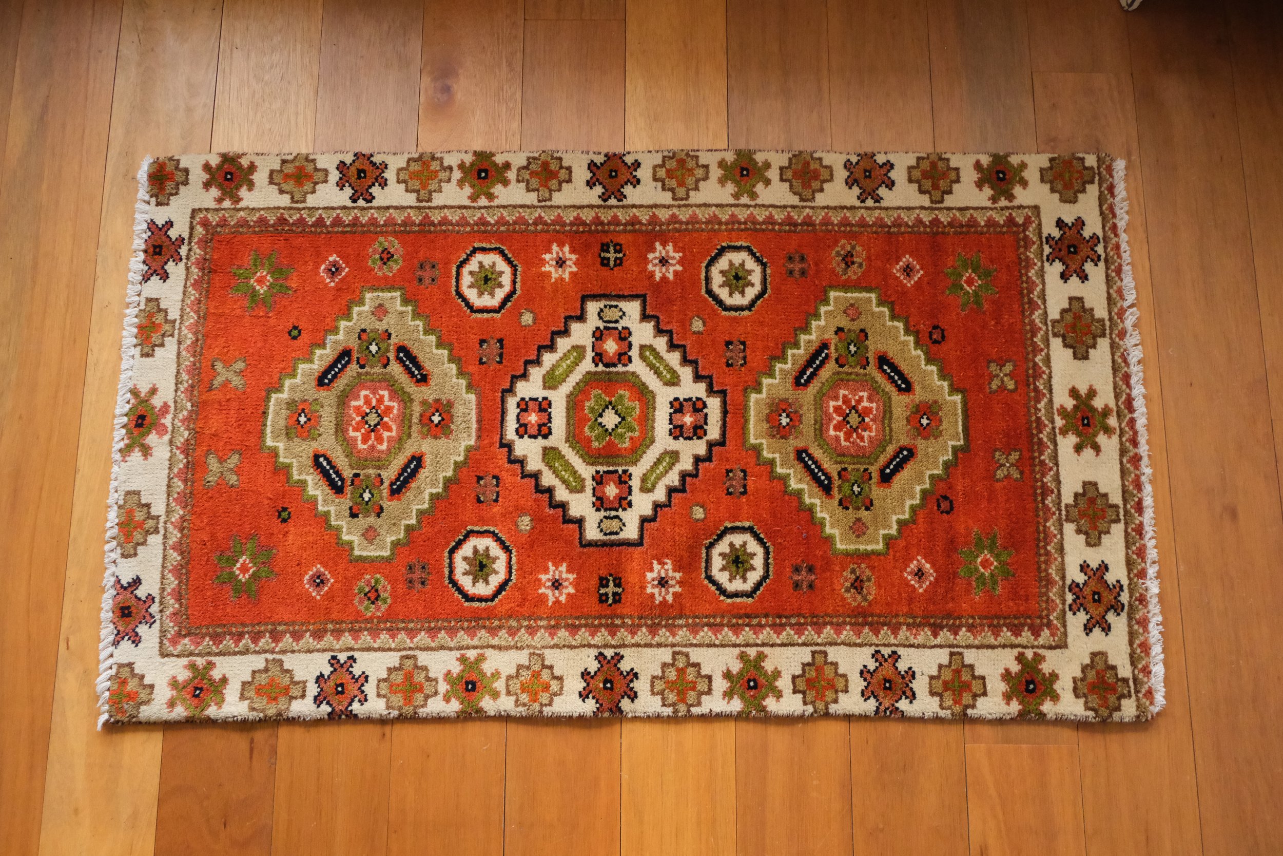 an overhead full view of the vintage turkish tribal rug