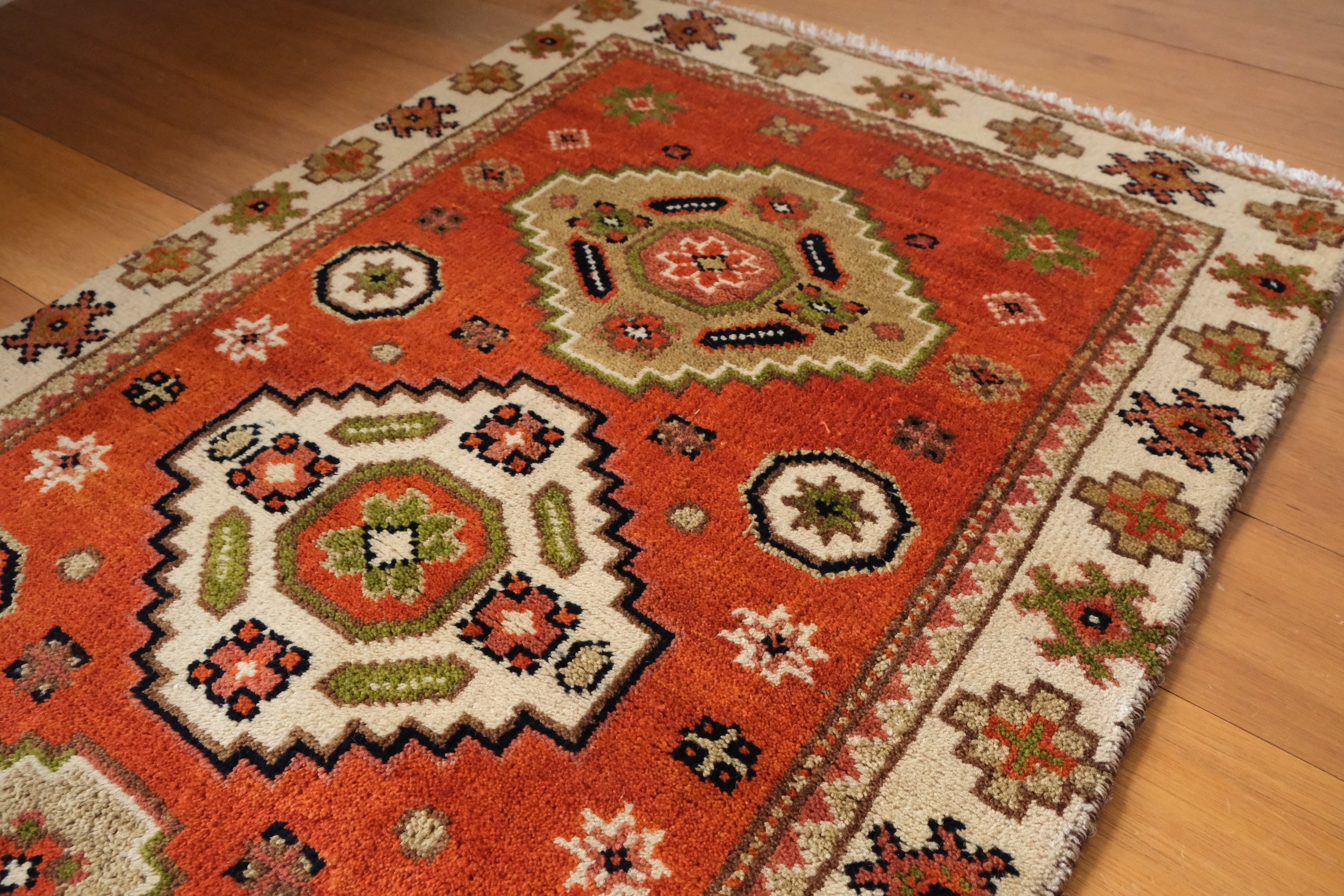 the turkish rug at a low angle showing the length of the pile is longer and more plush