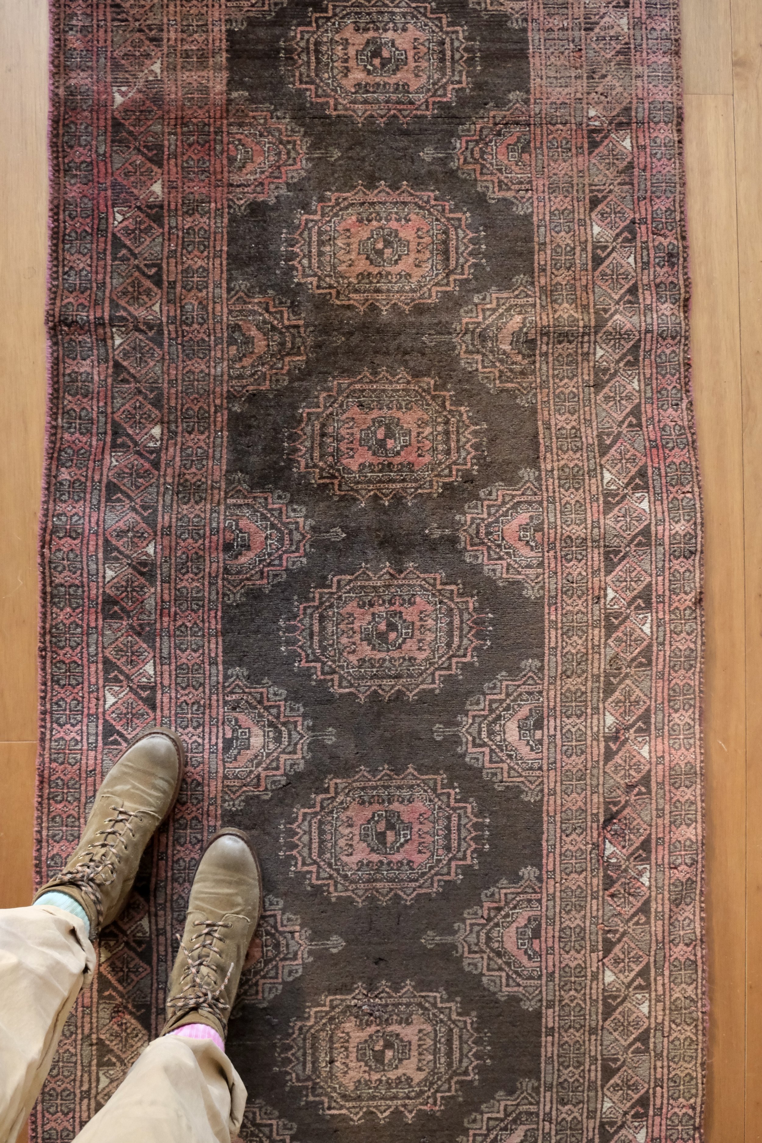 a close up overhead photo of the runner rug it has multiple medallions down the center