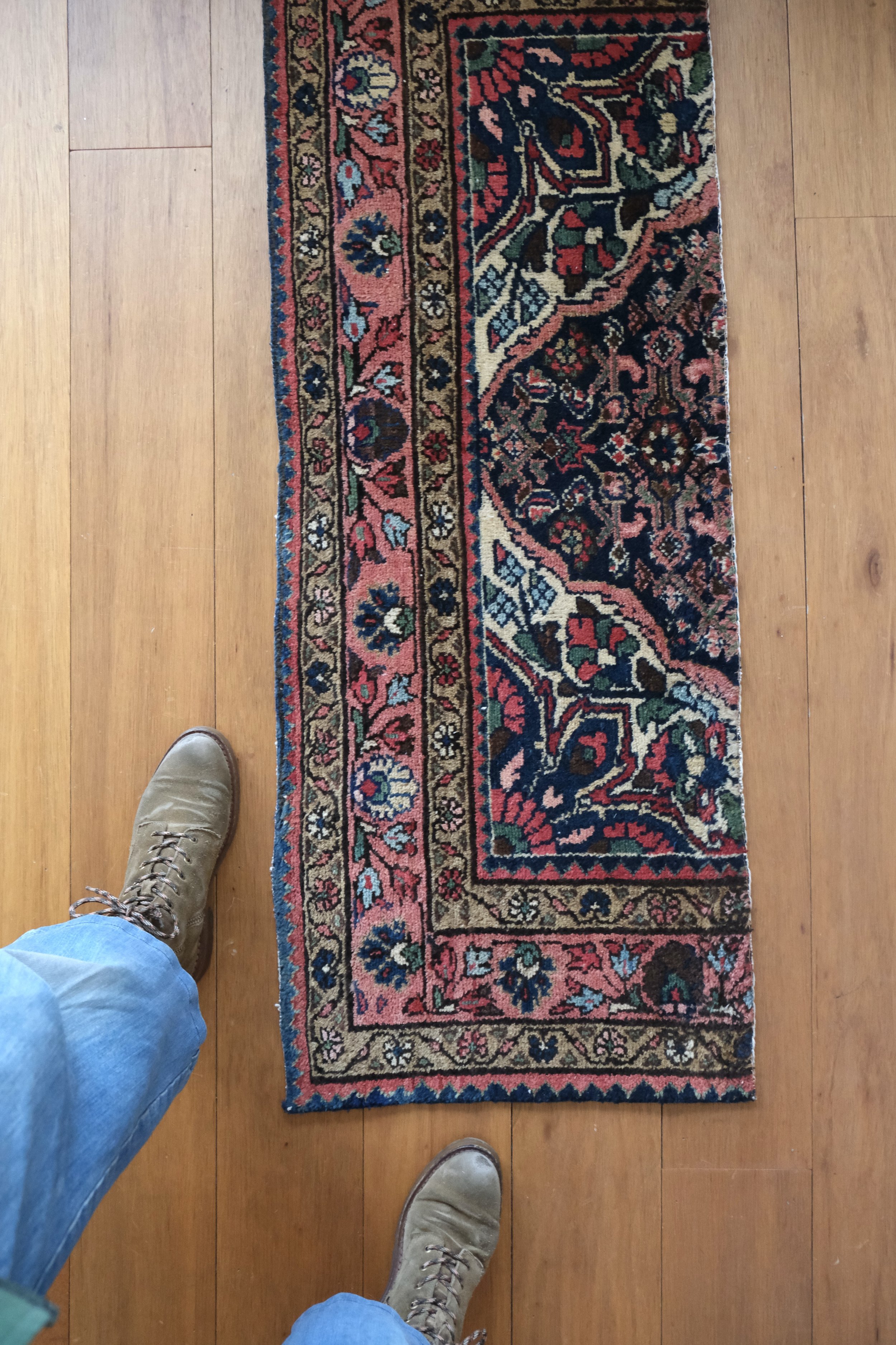 a close up overhead view shows the rugs garden design and intricate colorful pattern