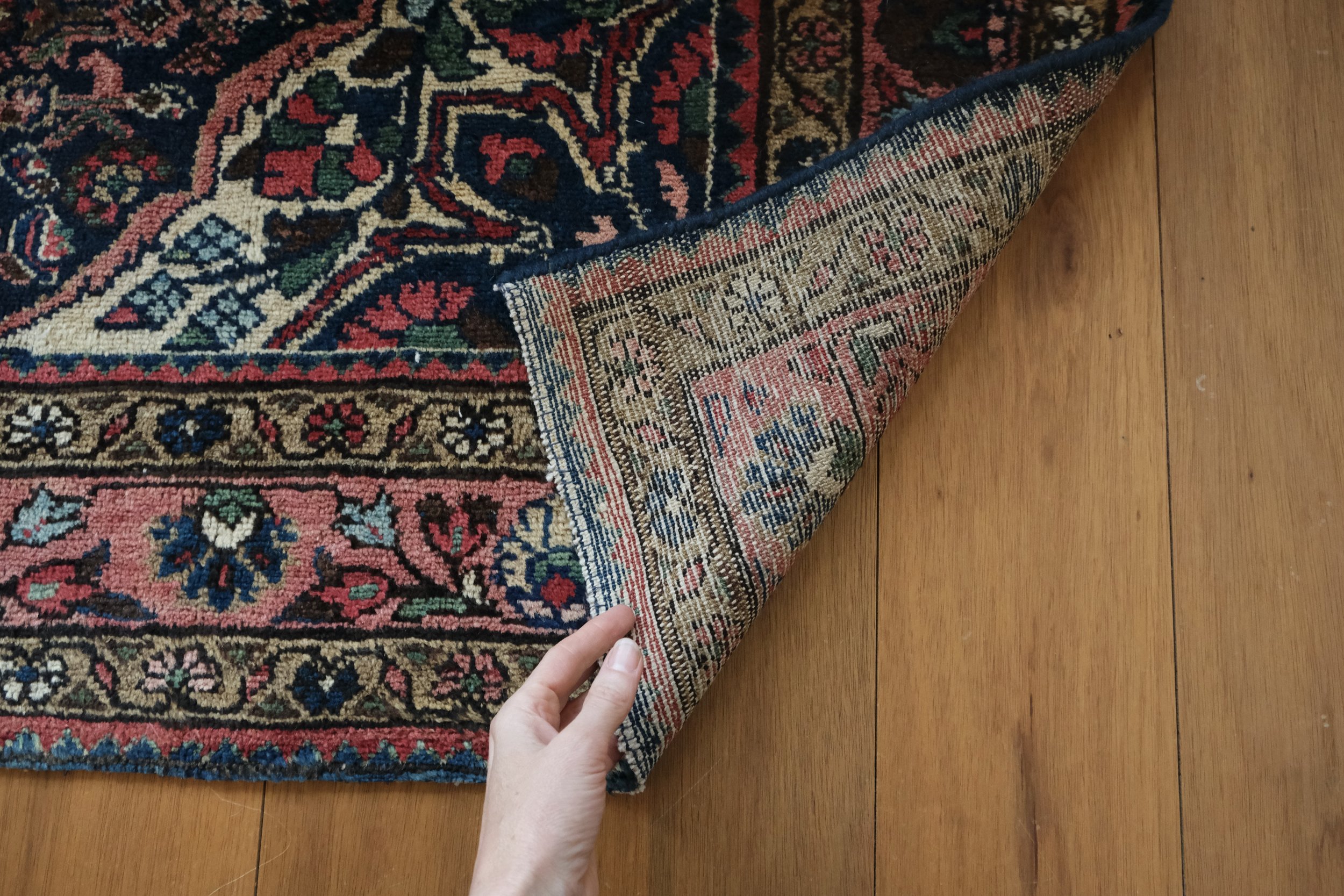 the backside of the rug shows its hand knotted quality