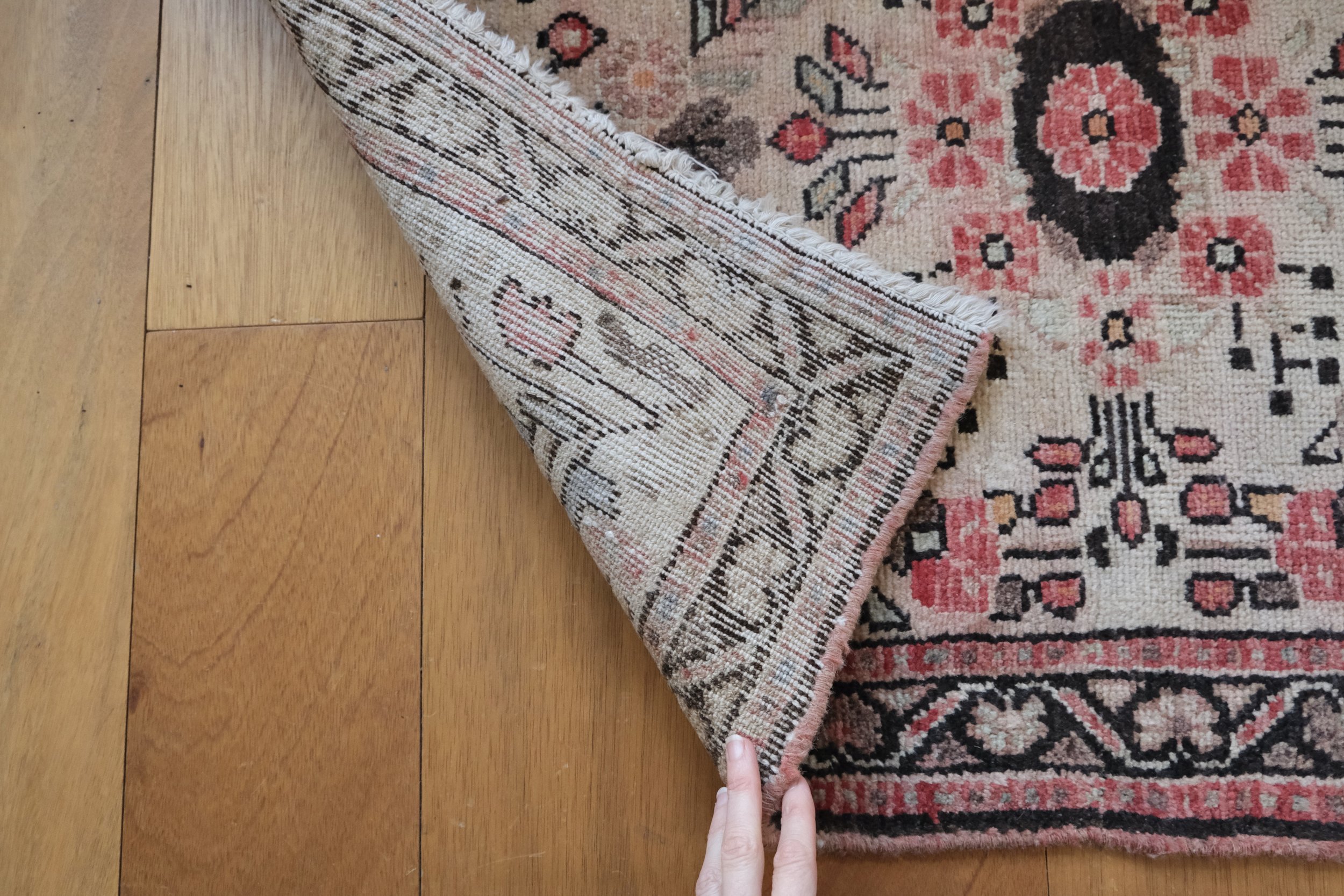 close-up of back of rug showing hand knotted qualities