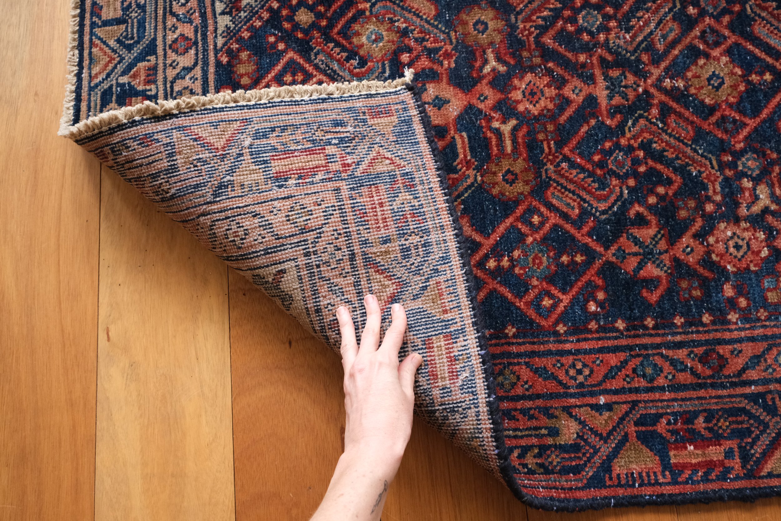 the backside of the rug and its hand knotted quality