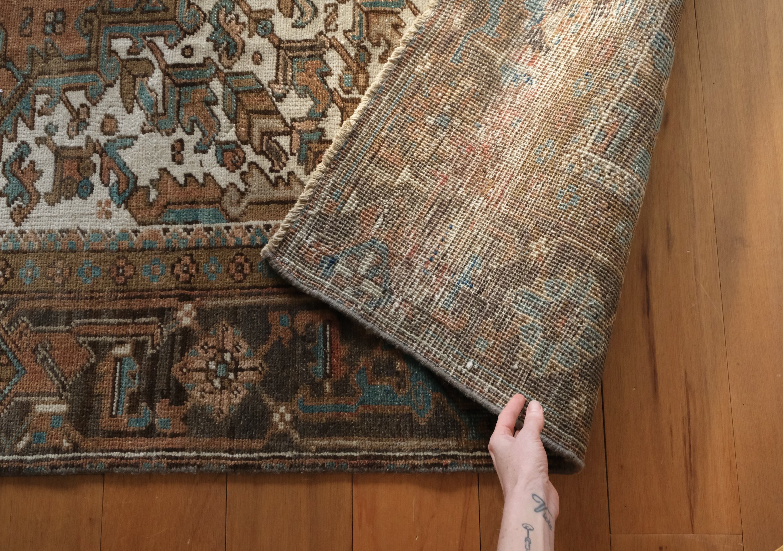 the backside of the rug shows its hand knotted qualities