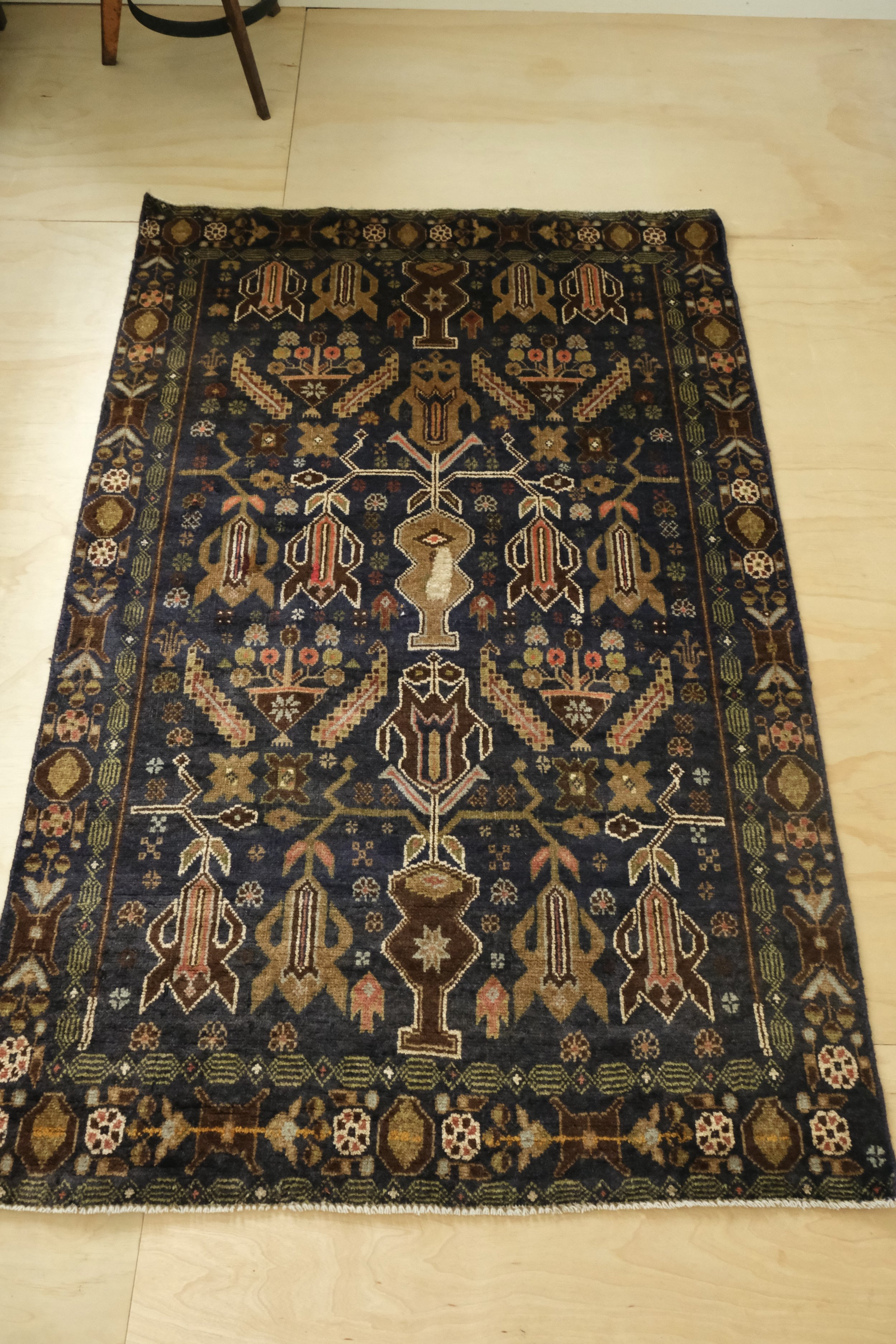 full view of rug showing midnight colors and small geometric motifs