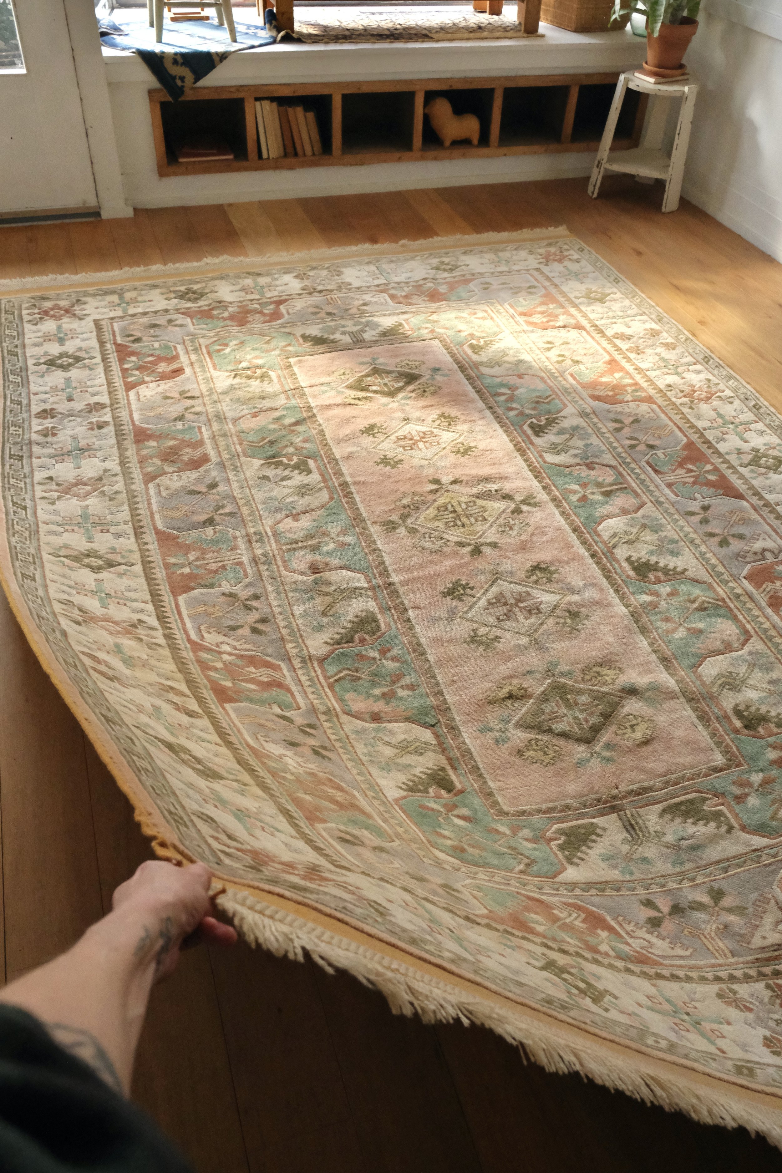 the vintage kurdish rug has soft pastel colors