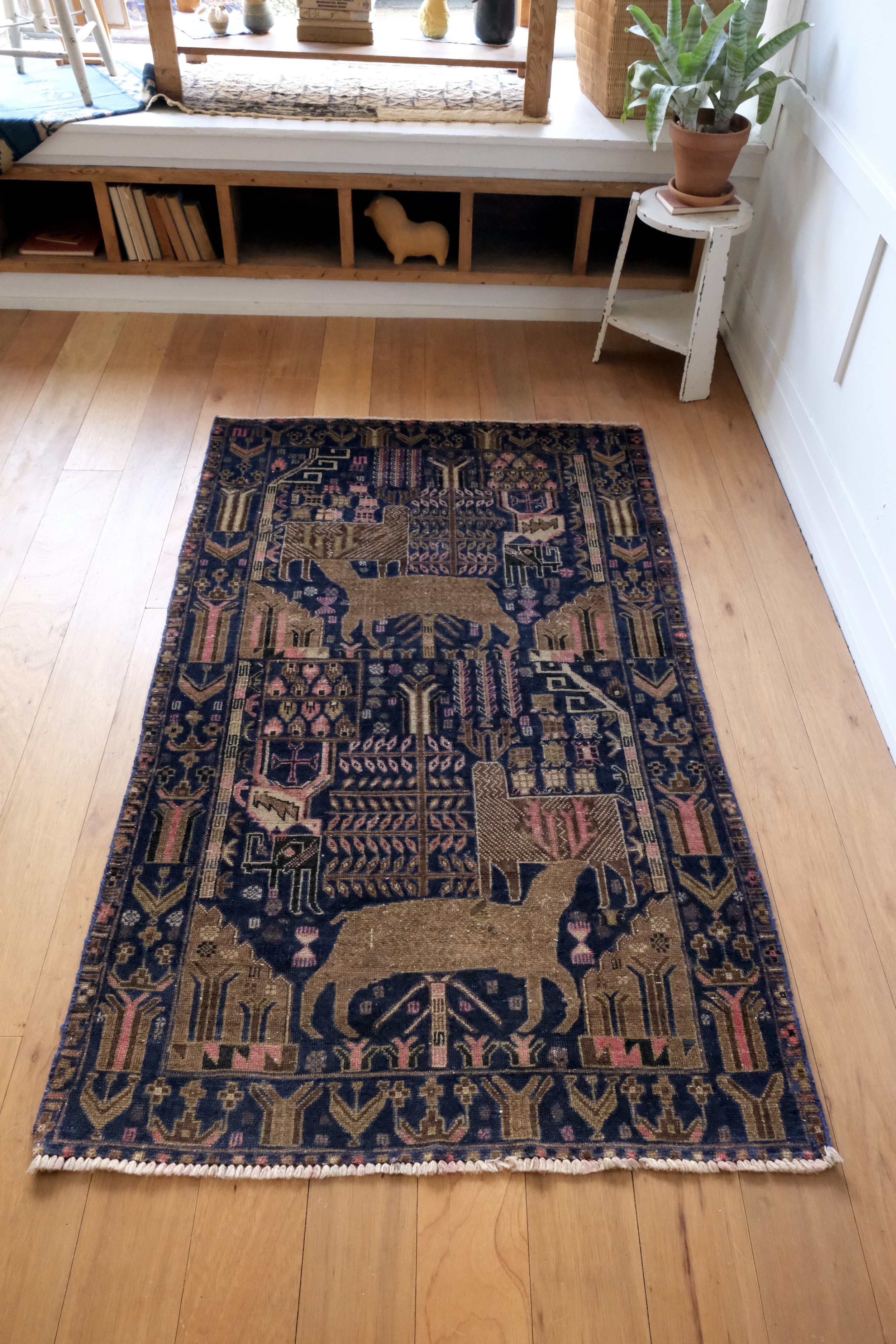 the rug has many deer and animals