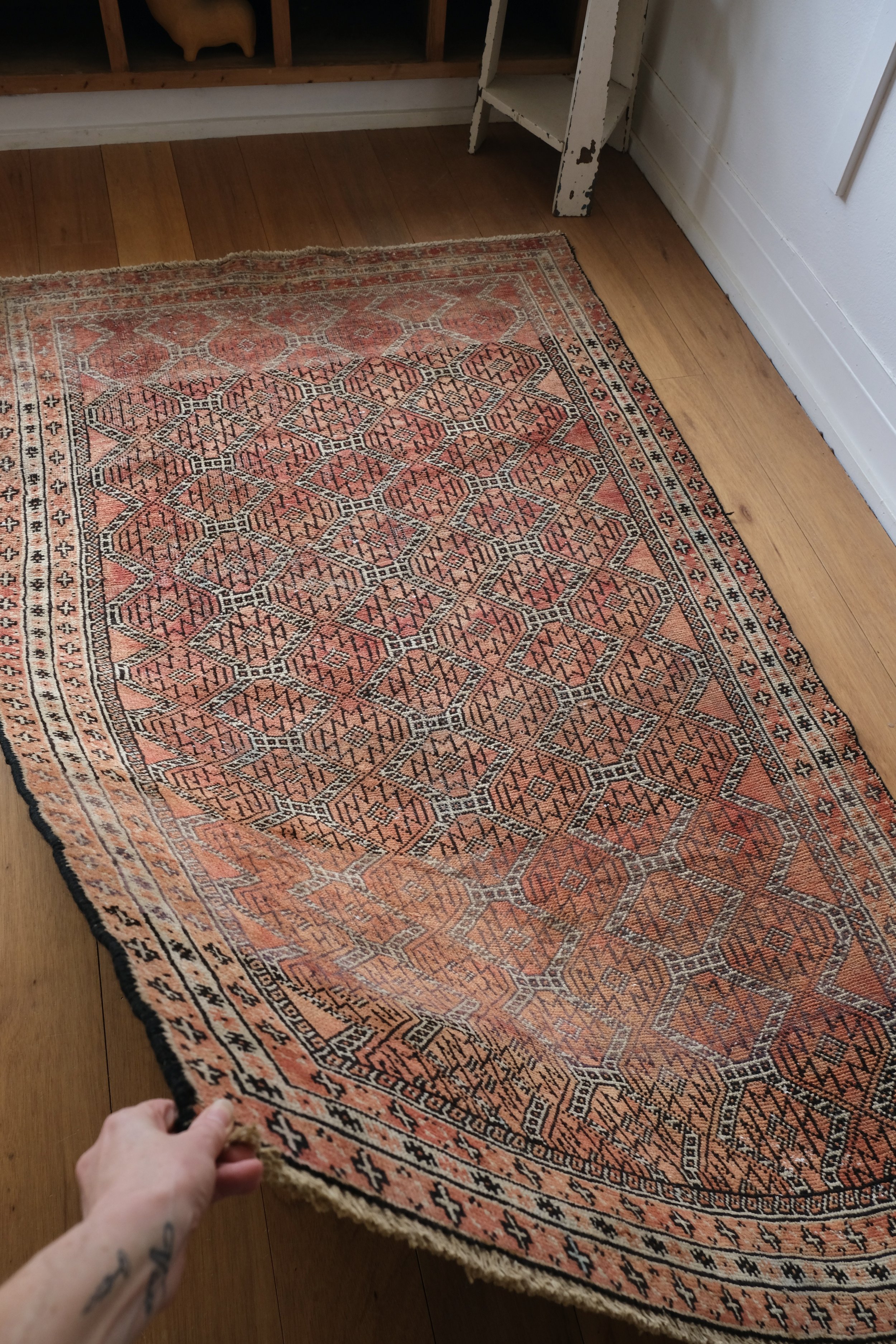 rug draping from hand