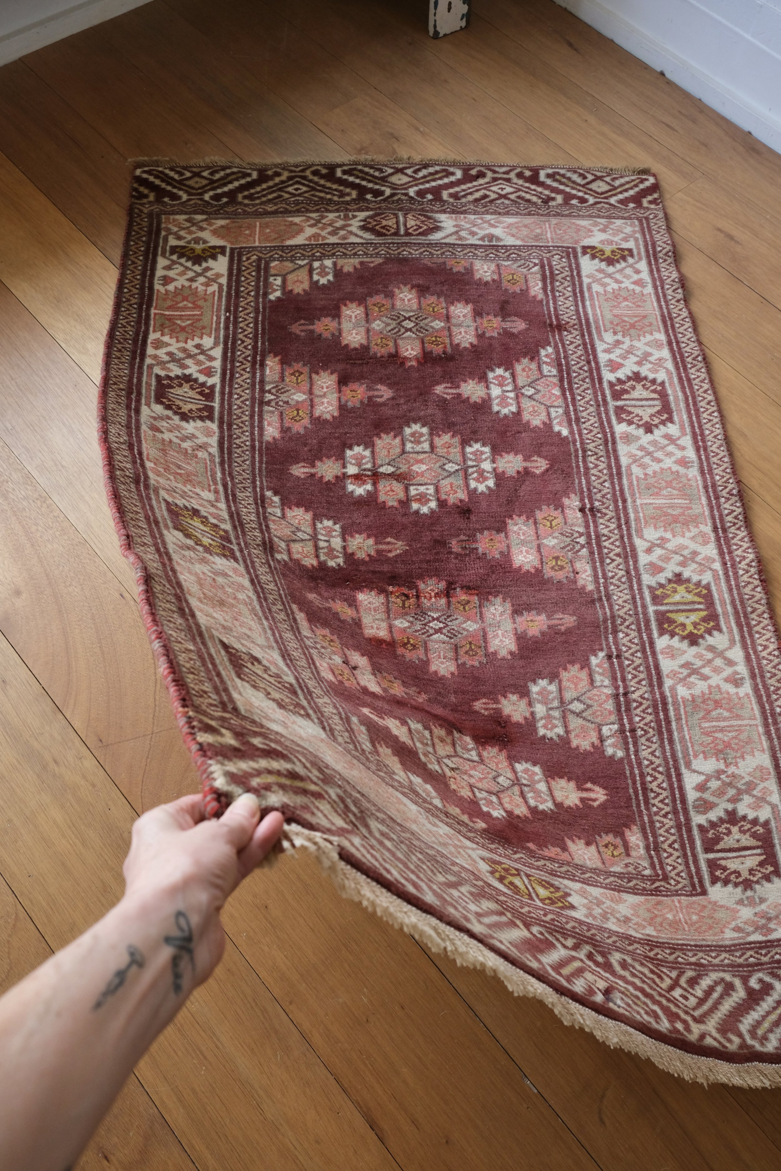 rug draping from hand