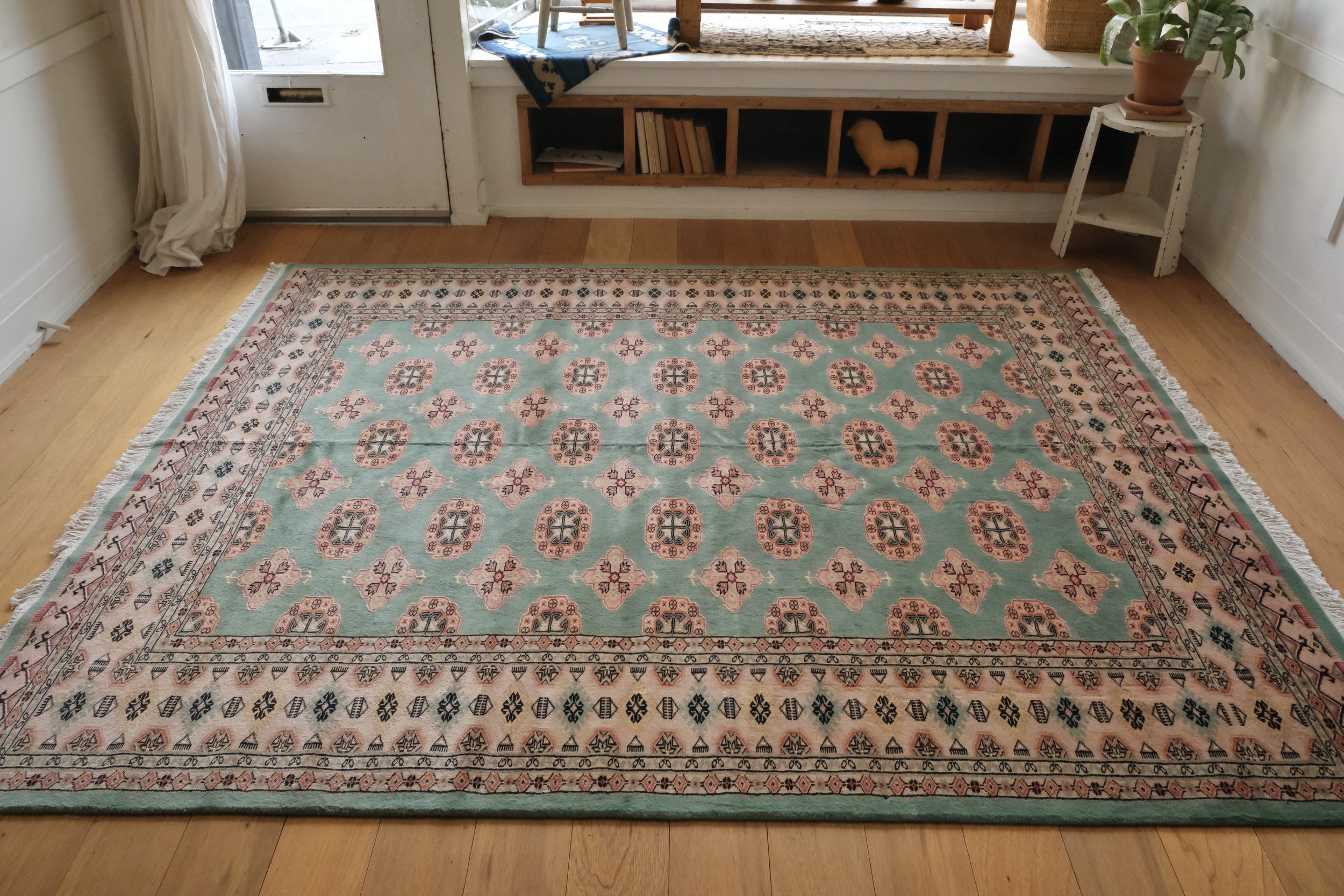 pakistani Bokhara rug displayed on wood floors