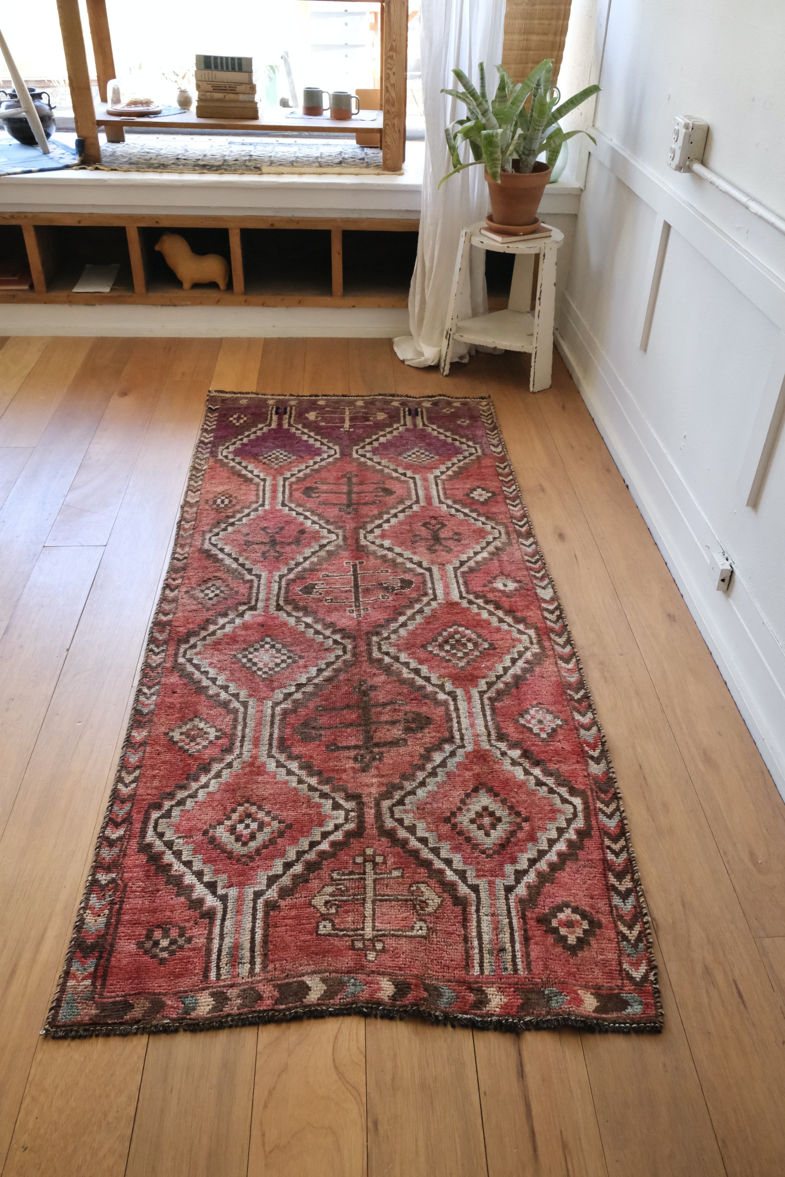 full view of Persian rug on wood floors