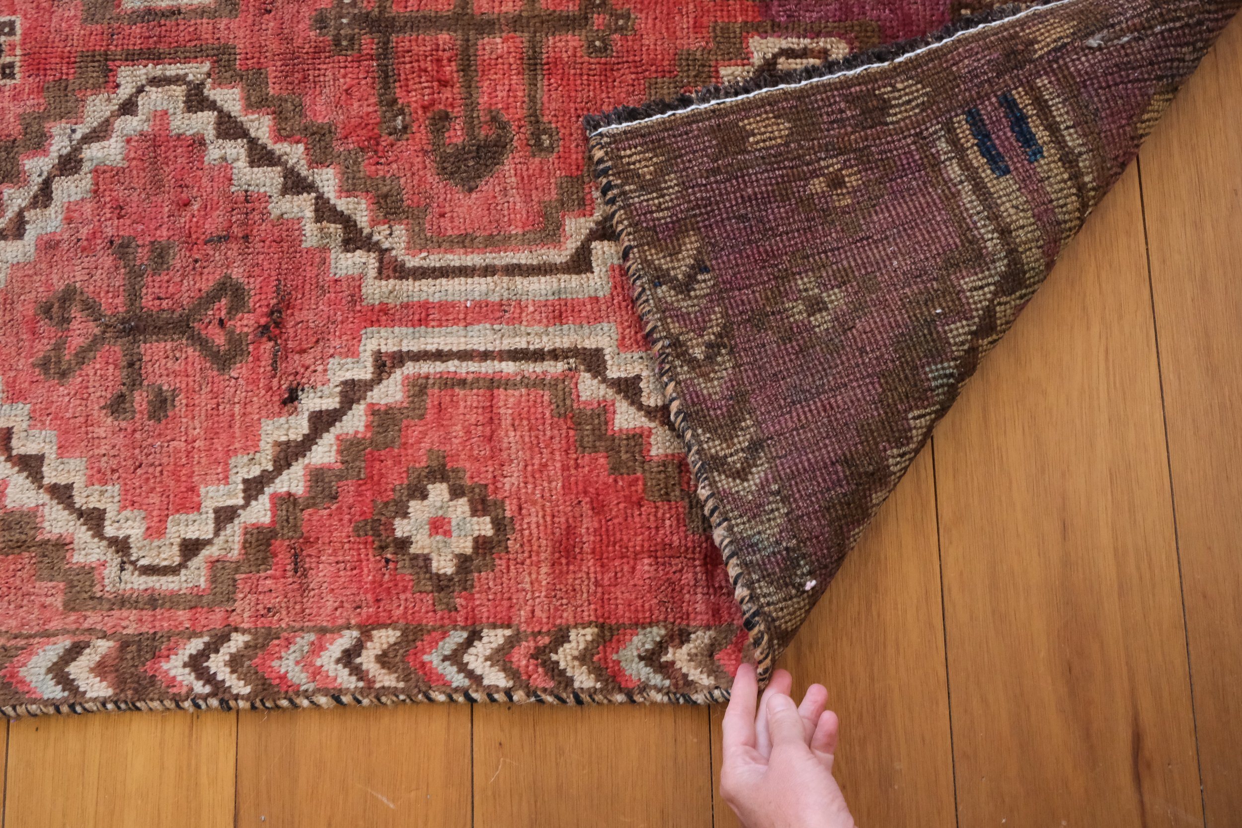 back of Persian rug with hand knotted construction