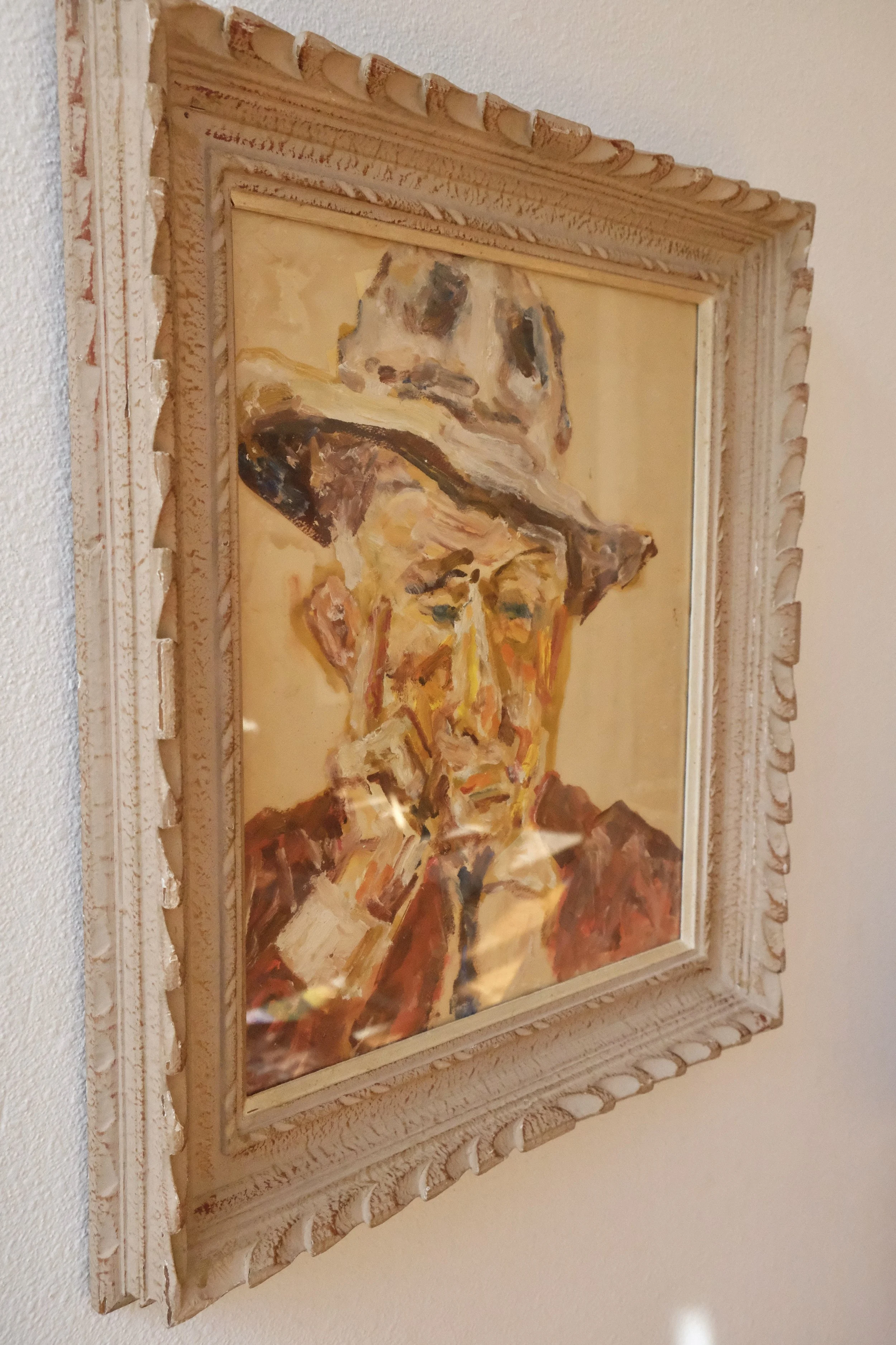 man in hat painting