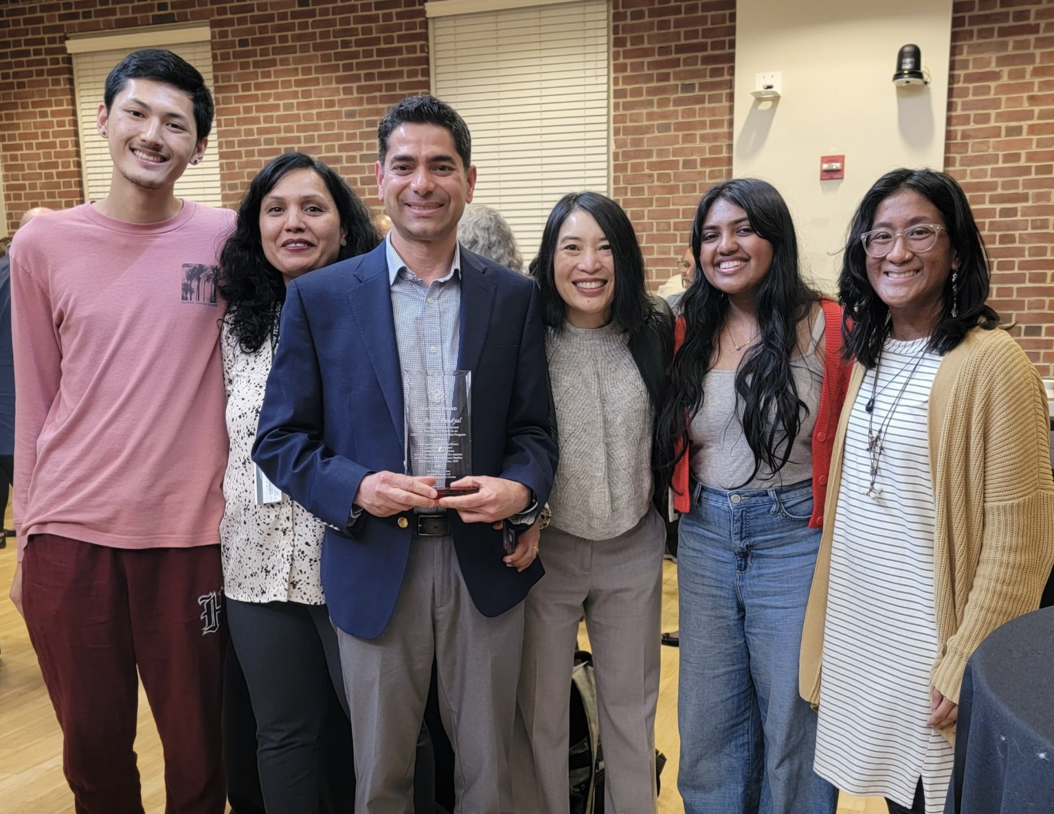group photo of Asian American Studies faculty, staff, and students celebrating Dr. Paudyal's teaching award