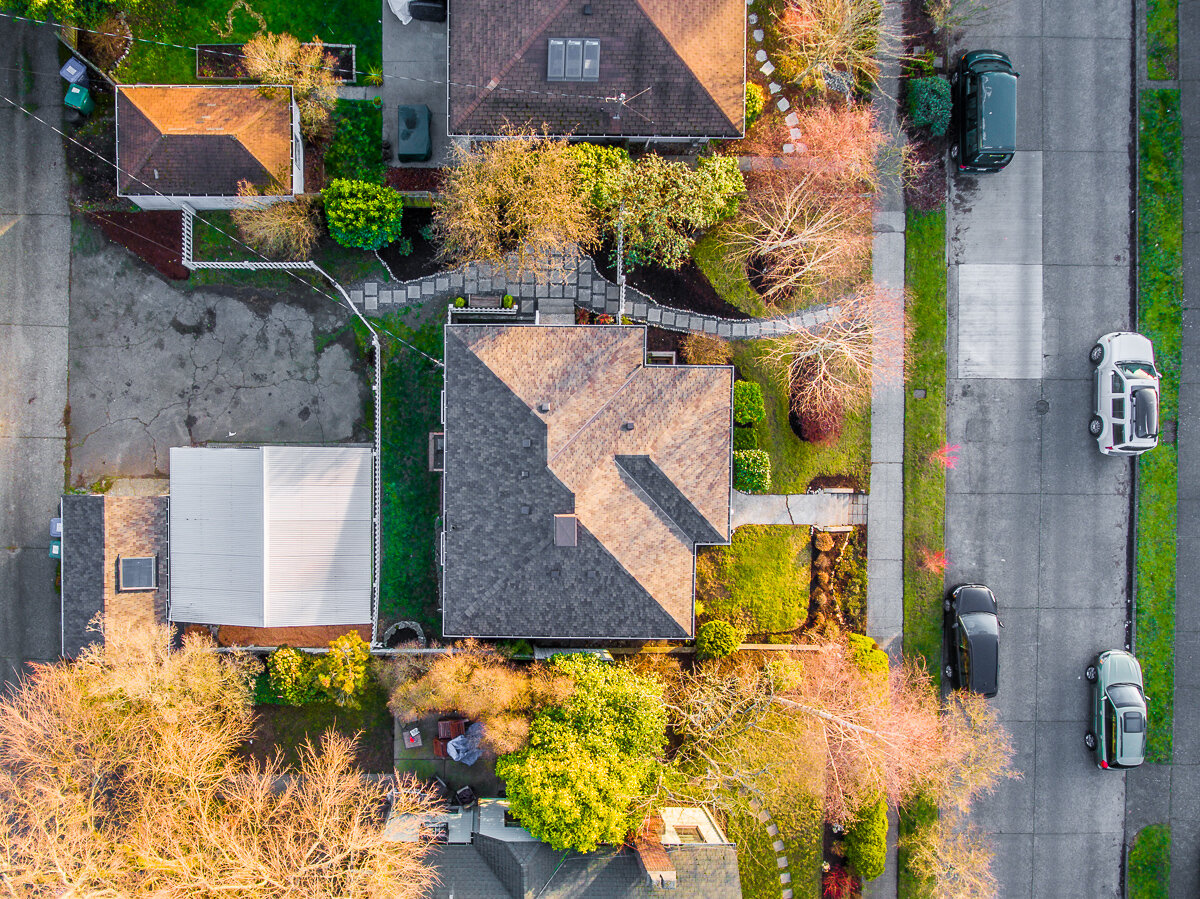 aerial drone birds-eye view of house, roof and landscaping