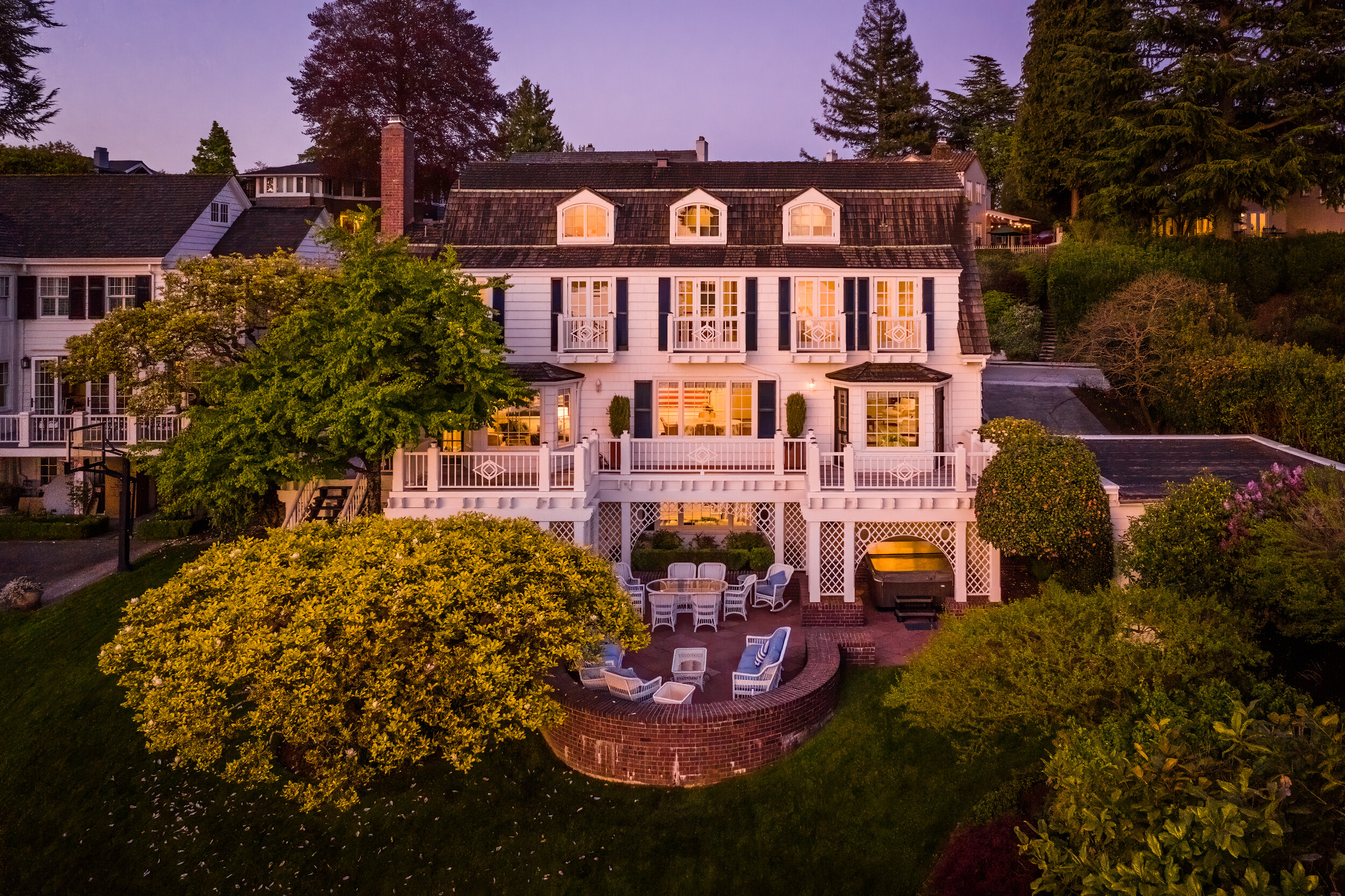 twilight drone shot of waterfront home