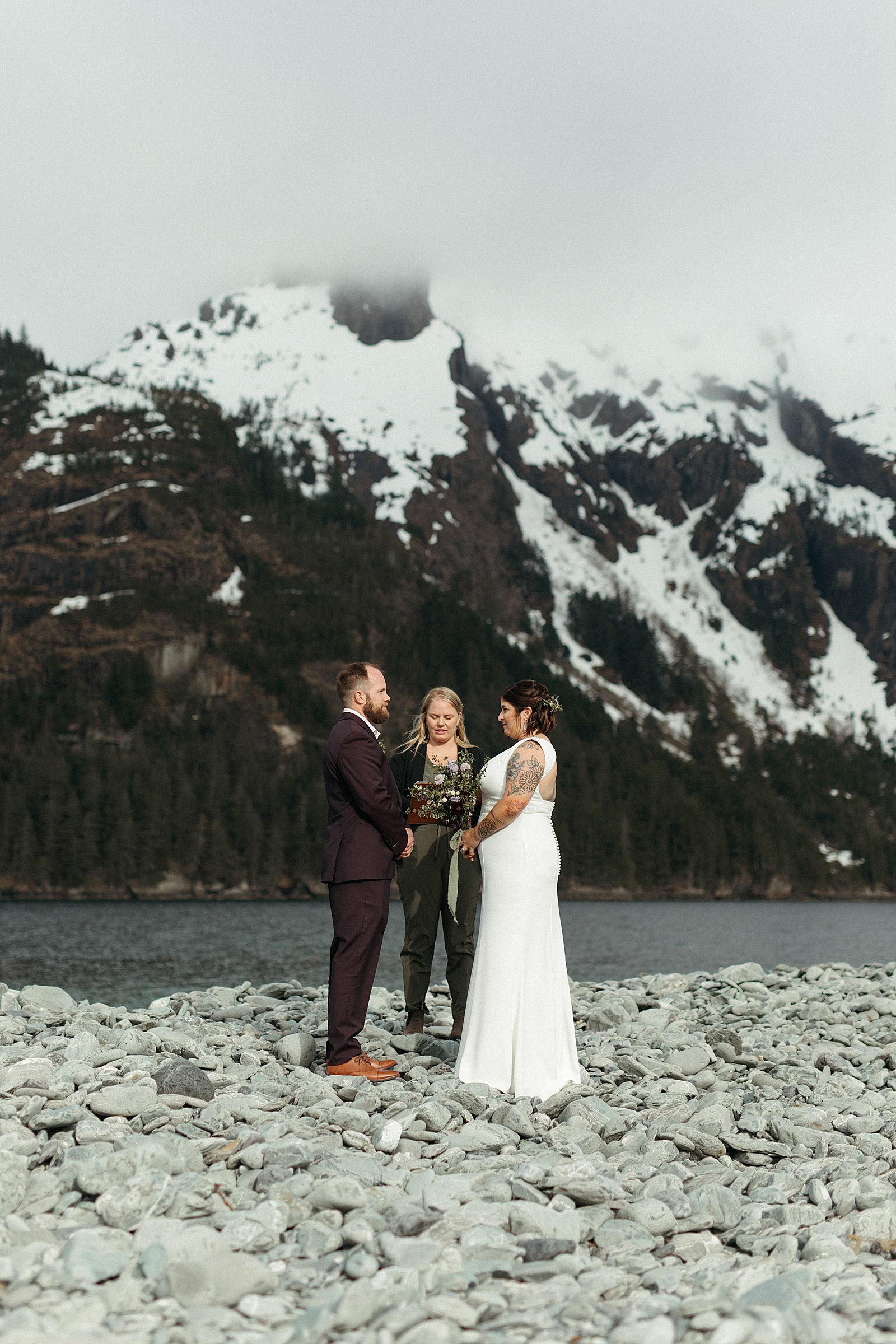  Bride and groom exchanging vows in private ceremony during Seward adventure elopement 