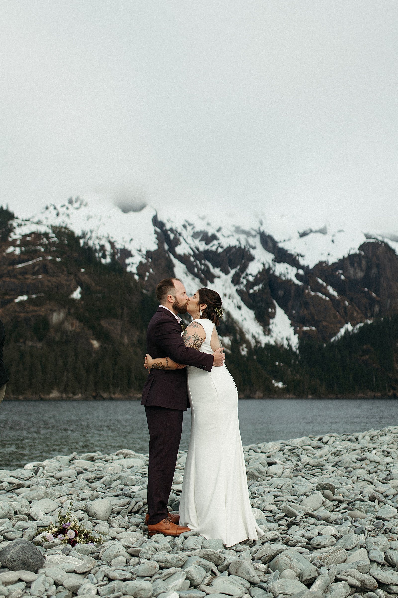  Newlyweds kissing after their ceremony at their Seward adventure elopement 
