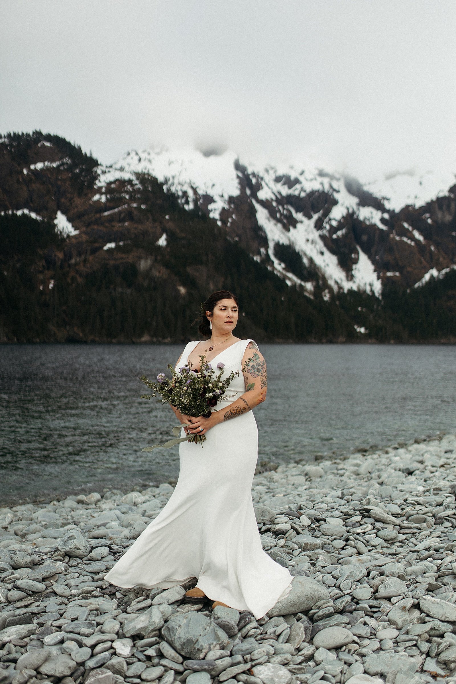  Bride standing in front of water and mountains by Rachel Struve Photography 