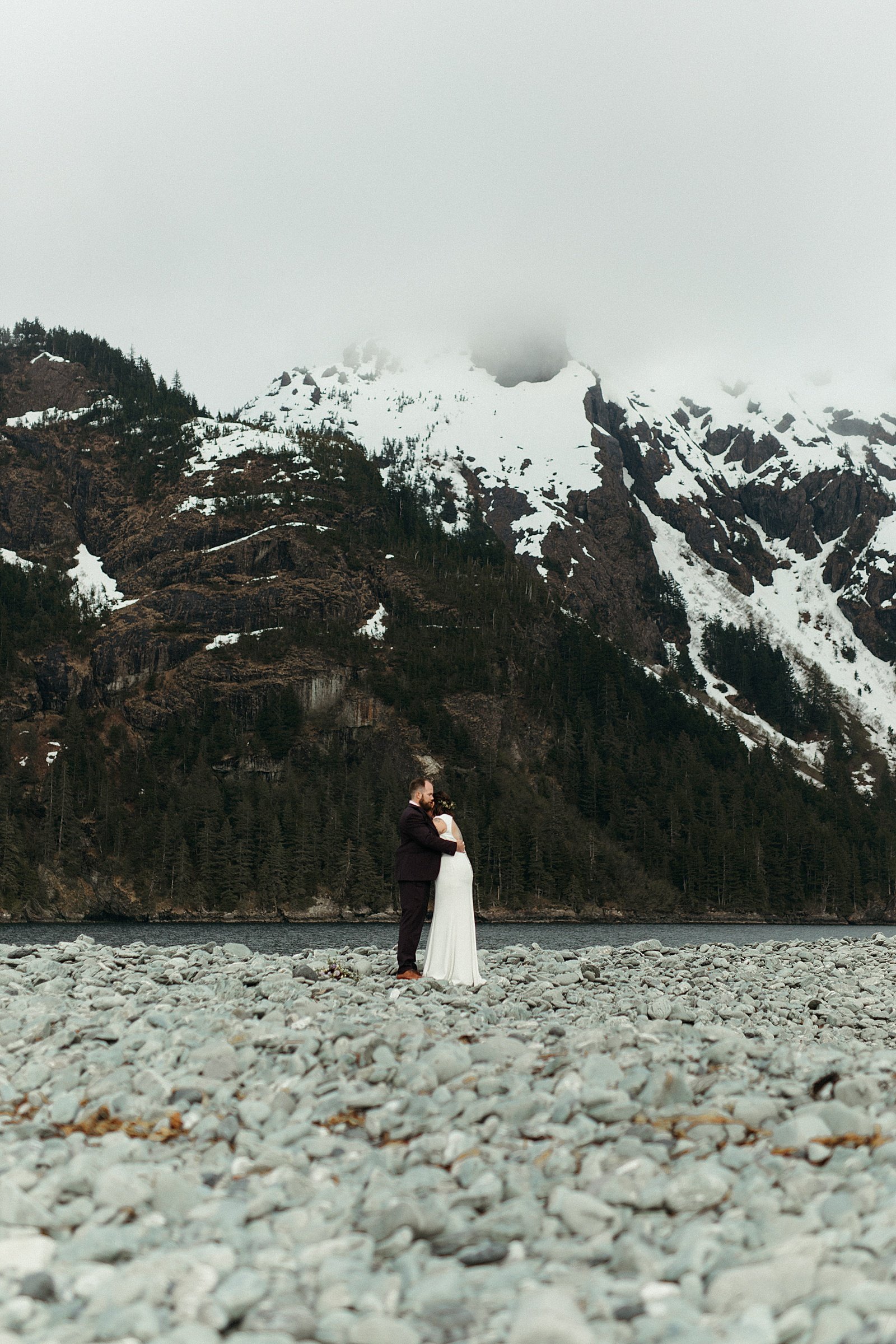  Newlyweds kissing on the beach after their ceremony by an Alaska wedding photographer 