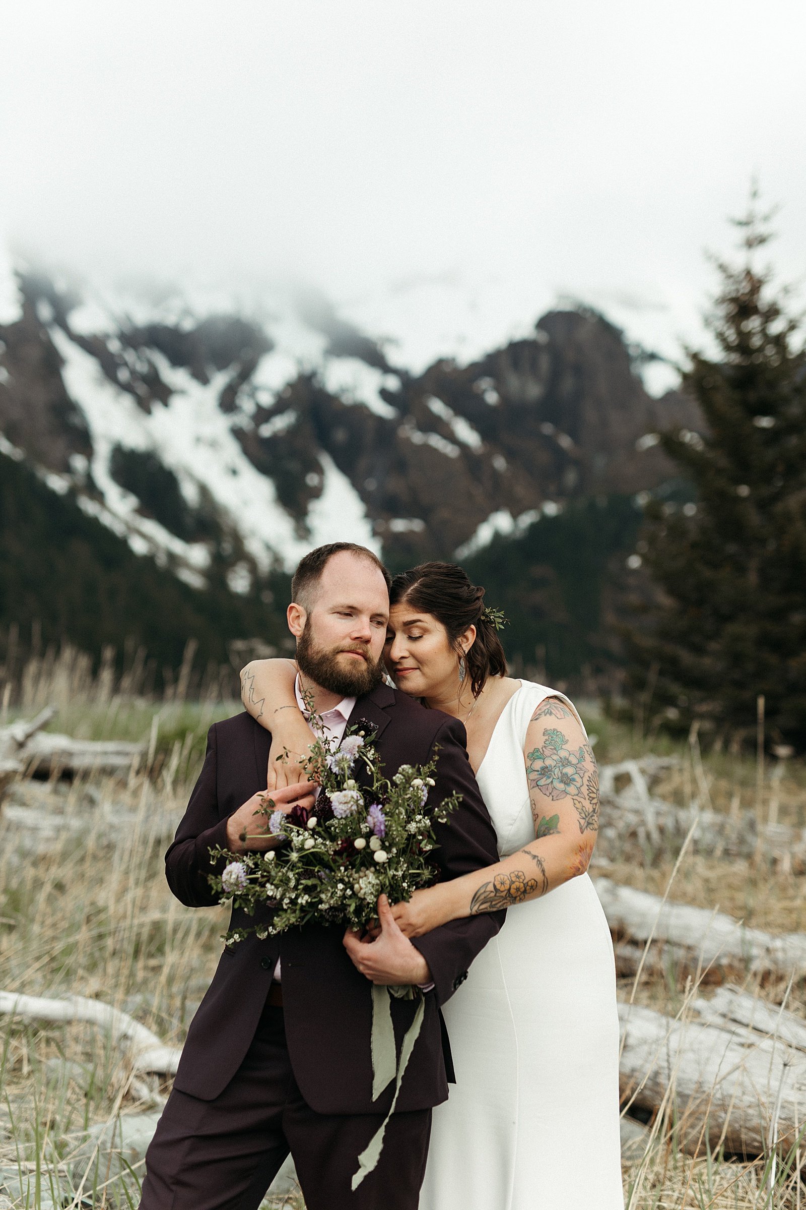  Newlyweds cuddling with mountains in the background by Rachel Struve Photography 
