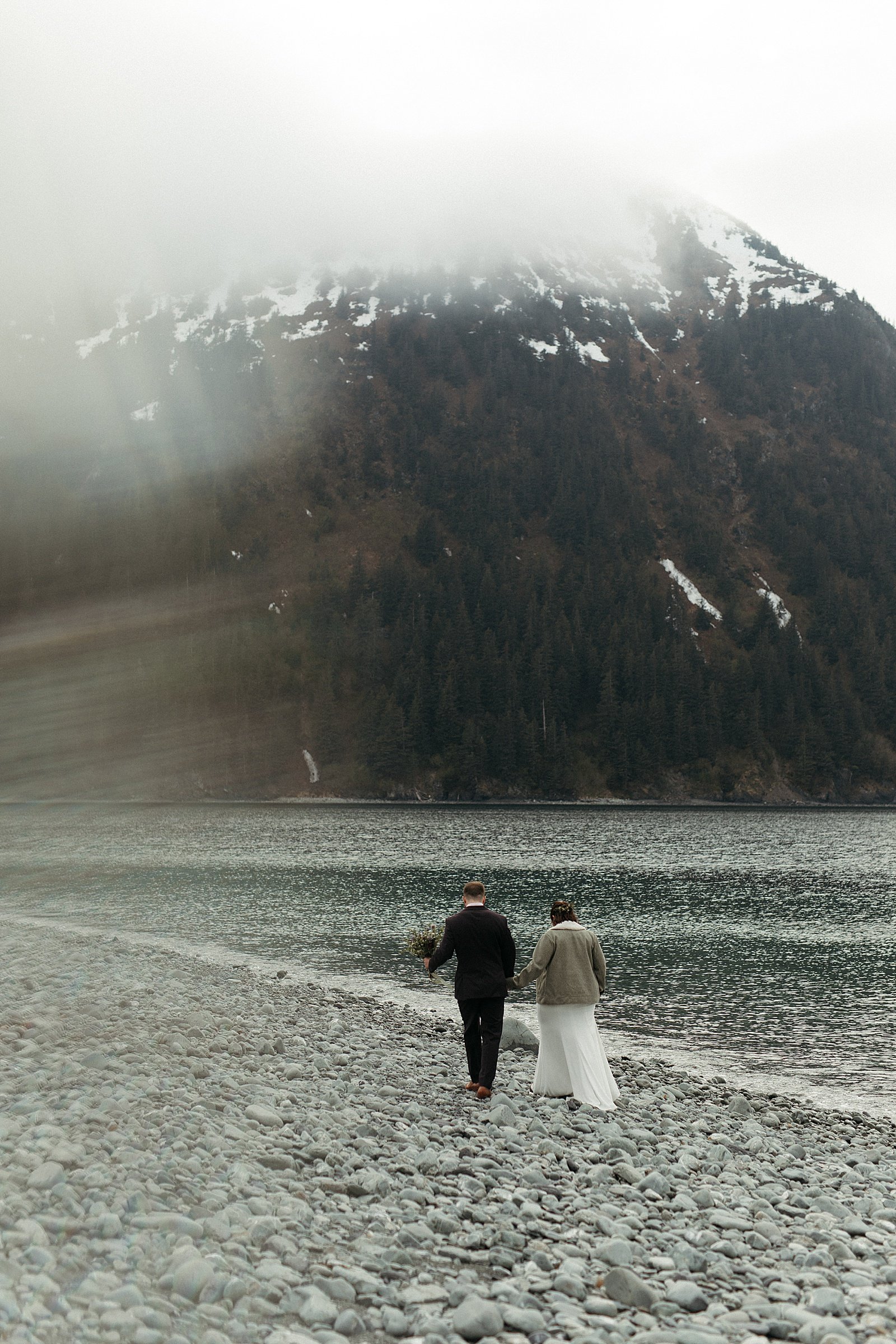  Bride and groom walking along beach from at Seward adventure elopement 