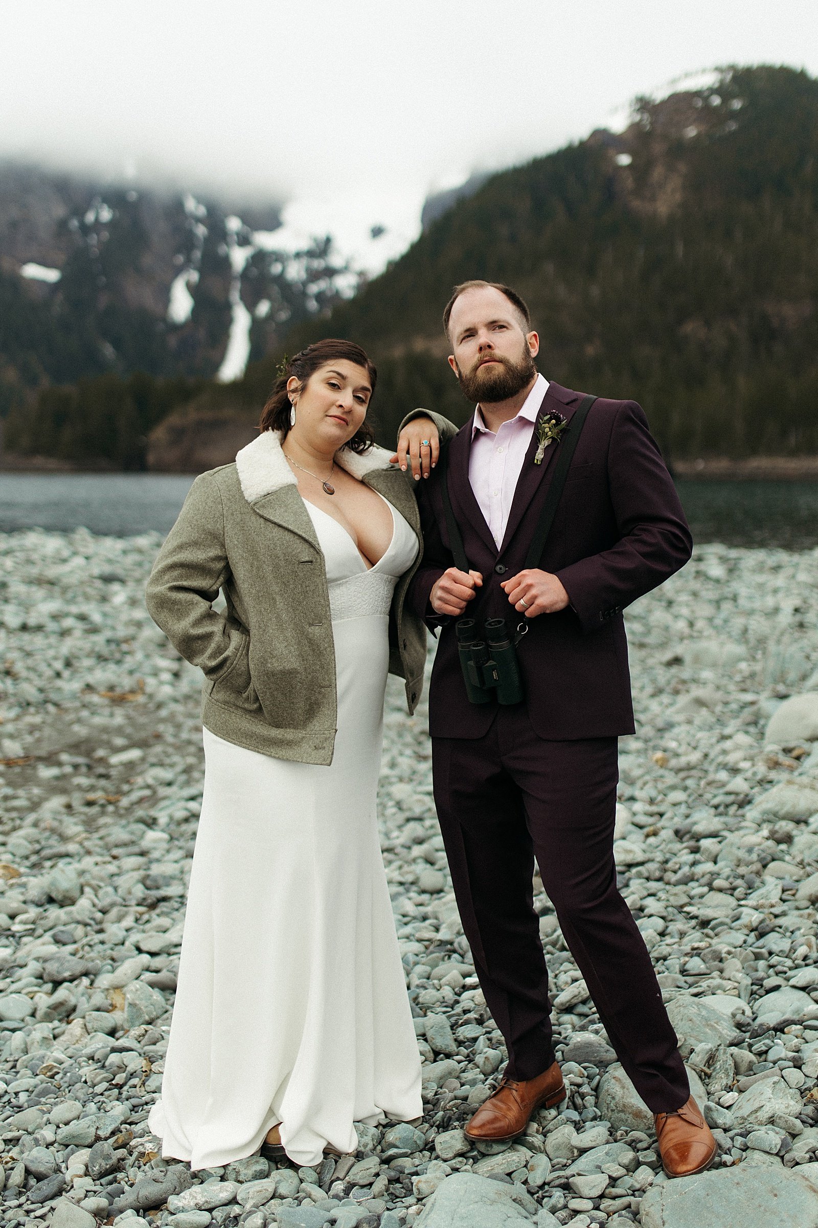  Newlyweds in coats in front of mountains by Rachel Struve Photography 