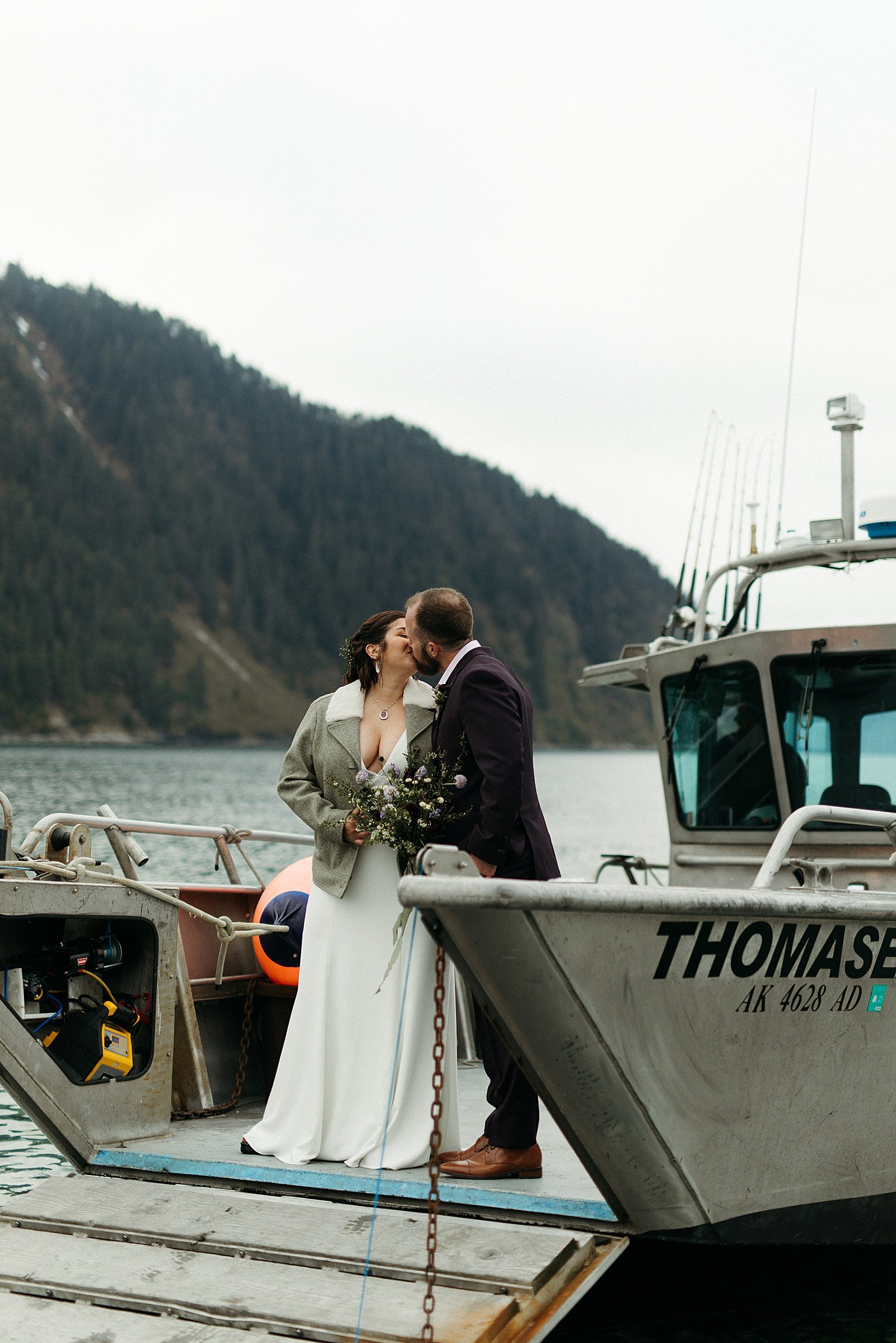  Newlyweds on boat after they said I Do by an Alaska wedding photographer 