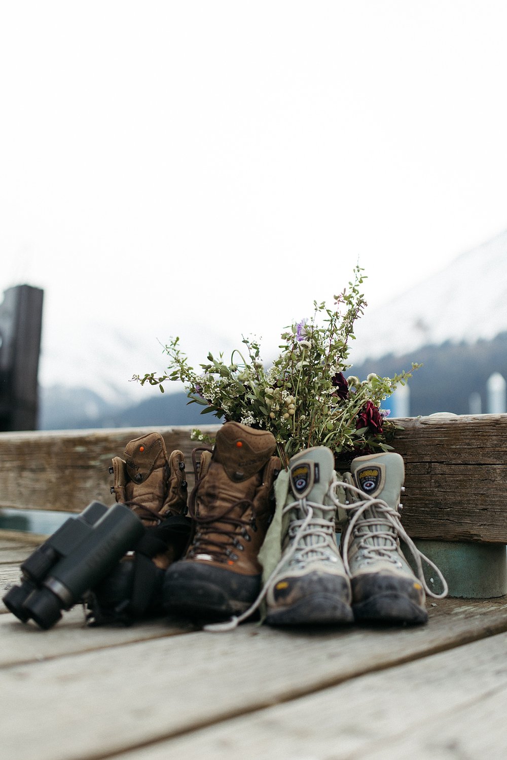  Boots on a dock with bouquet of flowers after Seward adventure elopement 