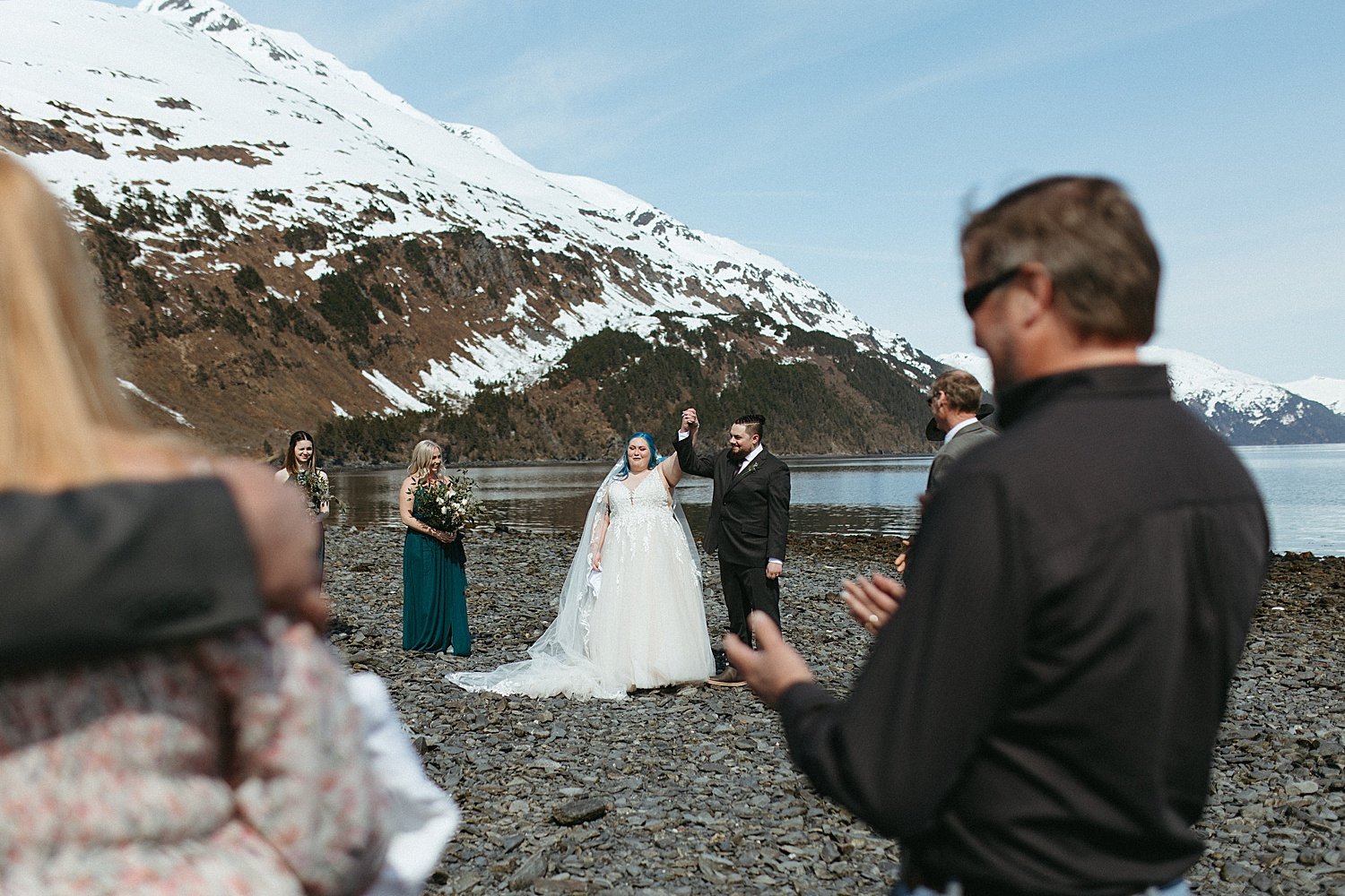  Newlyweds celebrating after saying I Do at their ceremony by Alaska Elopement Photographer 