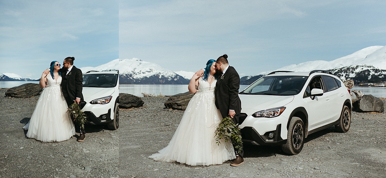  Newlyweds standing in front of a white car with mountains behind them by Alaska Elopement Photographer 